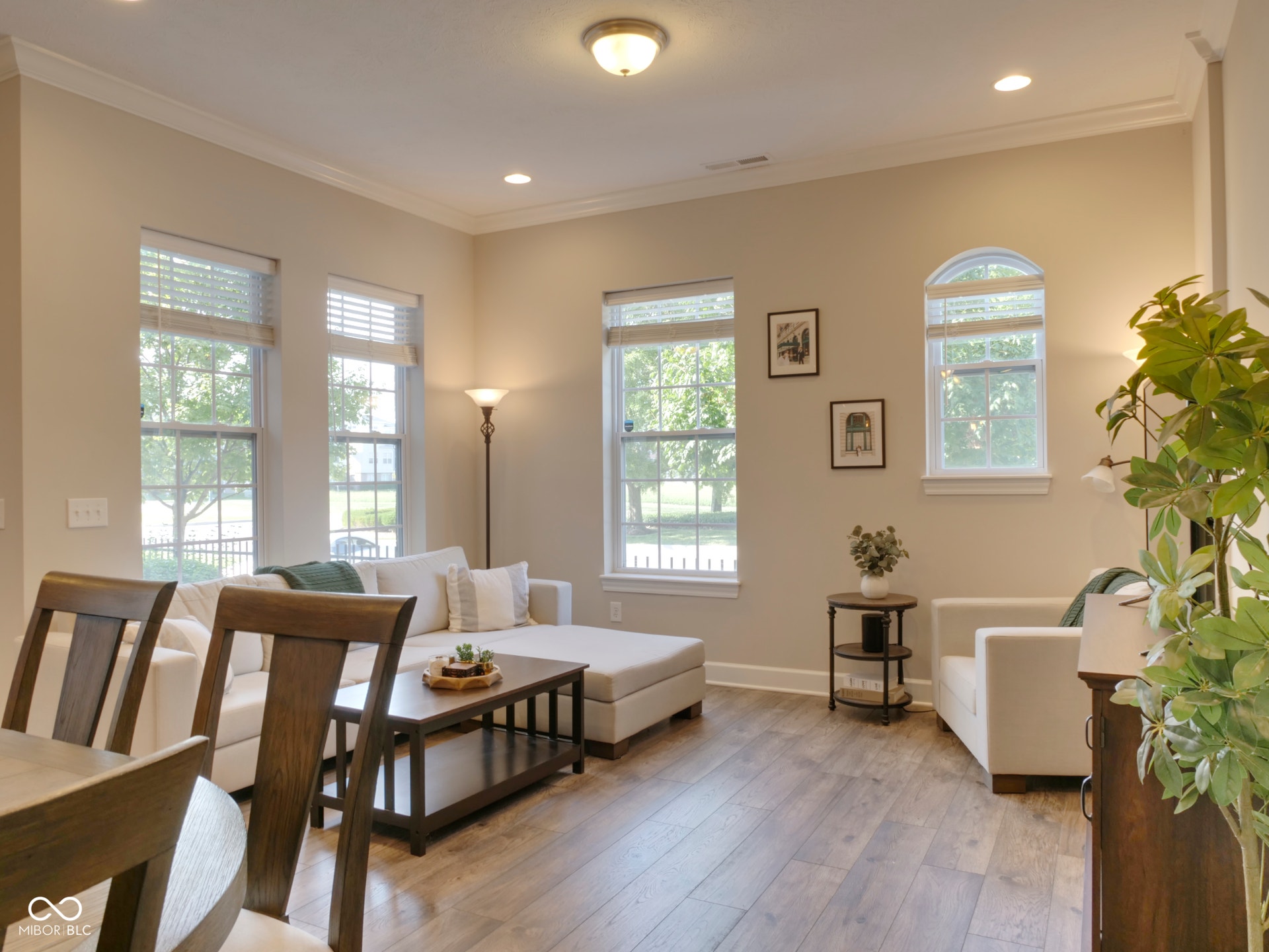 Wood-finish flooring throughout, complemented by crown molding and recessed lighting