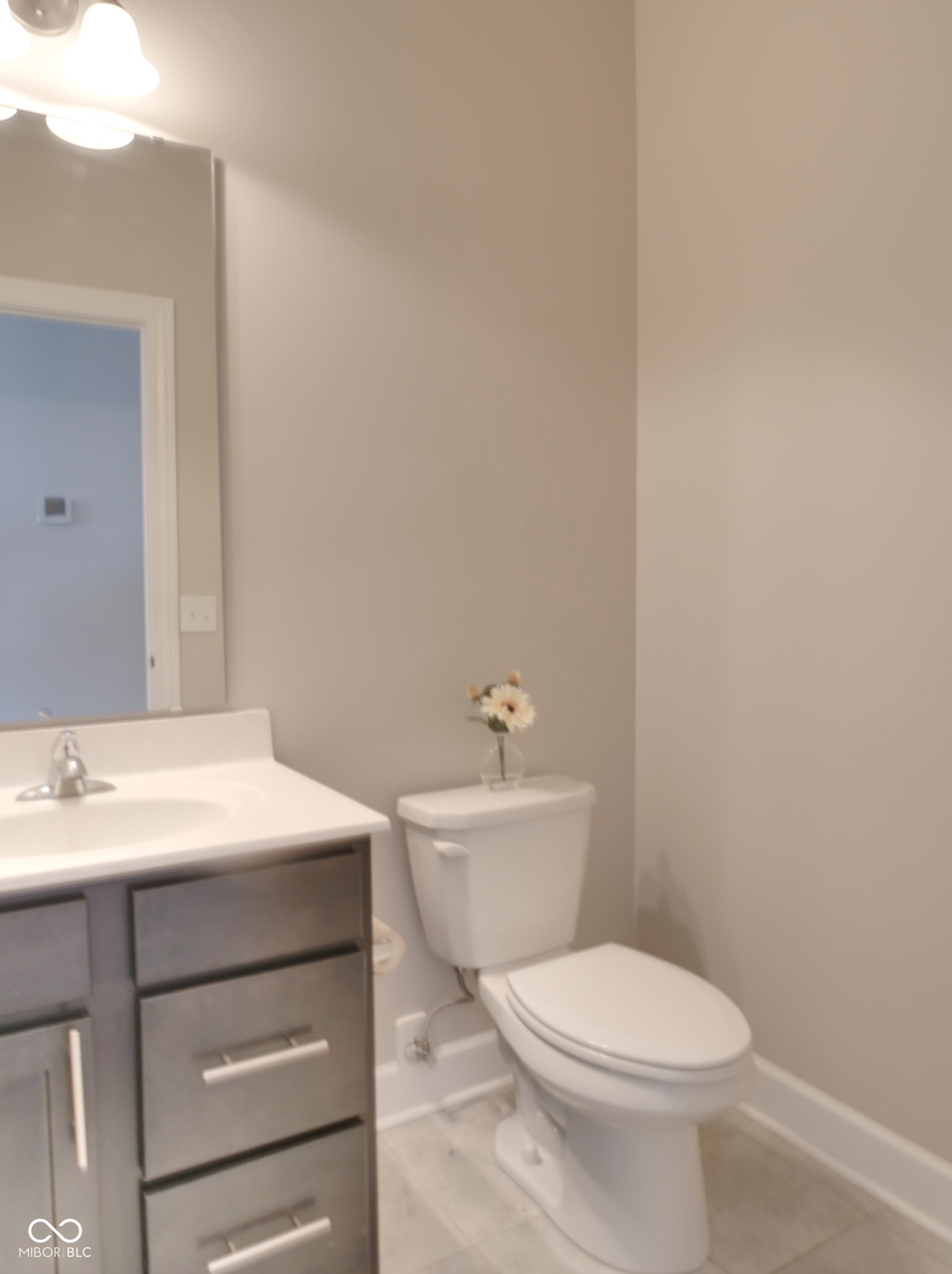 Modern vanity with brushed nickel hardware, integrated sink, and a single-handle faucet Half Bath in Bonus room area 3rd floor