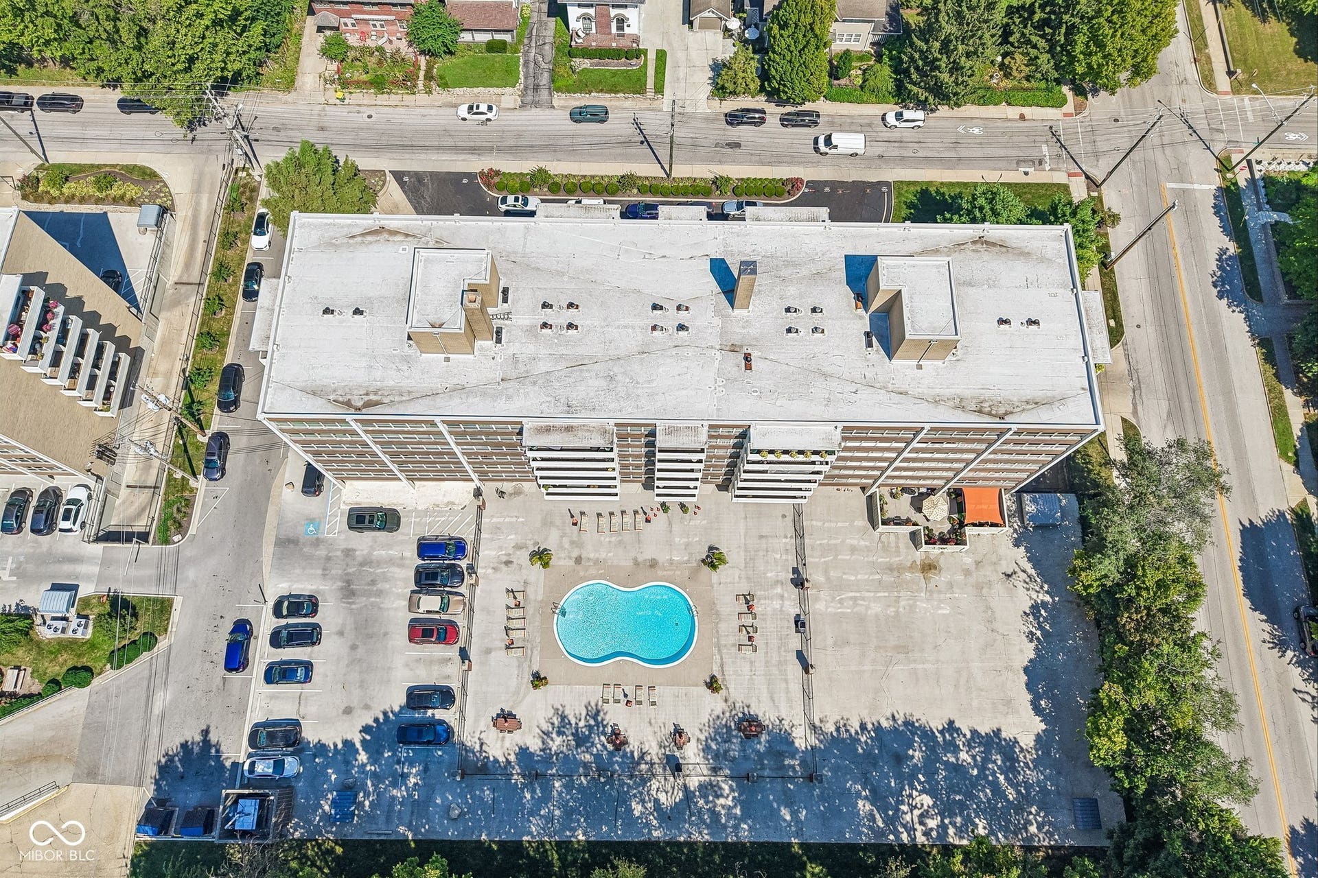 East Building: Multi-story building featuring multiple balconies, a swimming pool, and dedicated surface parking