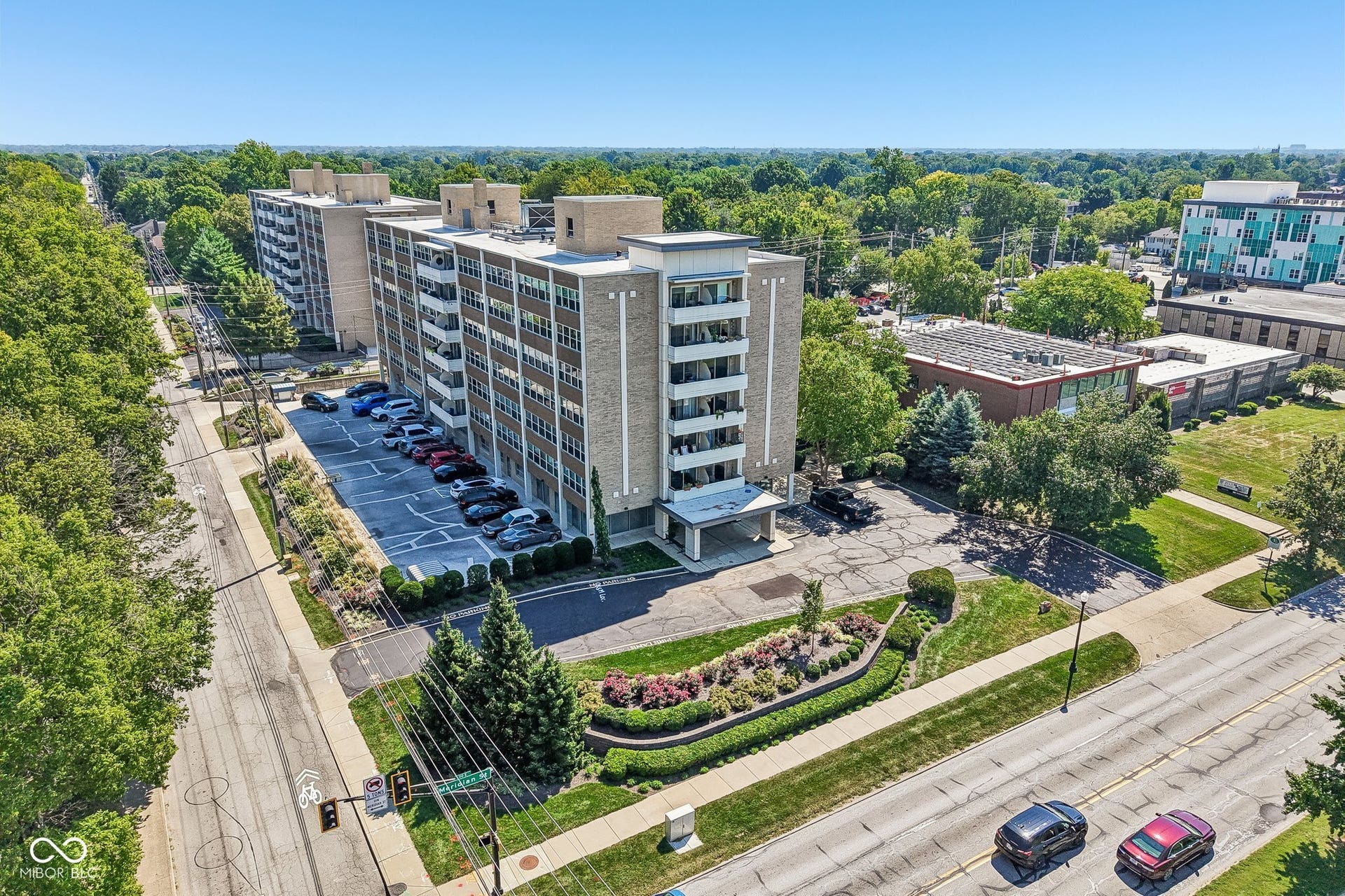 Multi-story facade featuring stone-finish panels and multiple balconies