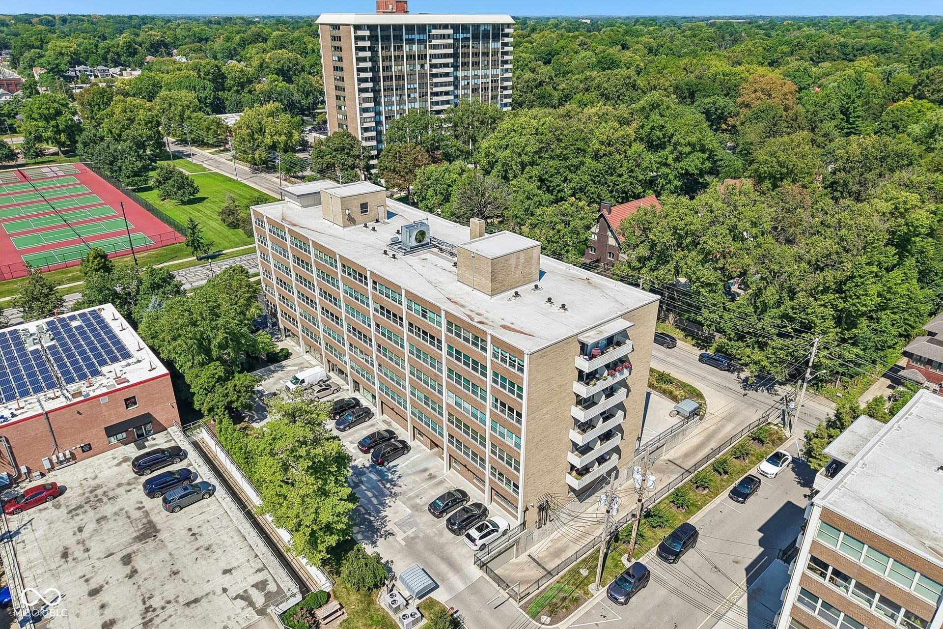 Multi-story building featuring a brick exterior and multiple balconies
