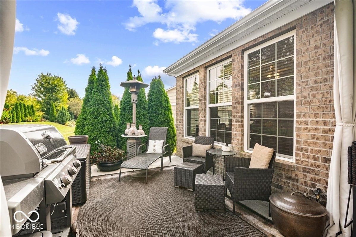 Extended patio on both sides to the full width of the home, added irrigation system, ceiling fan in the covered patio, gorgeous established landscape, room for couch, table, grill - all of it. The patio is large and is both covered and uncovered.