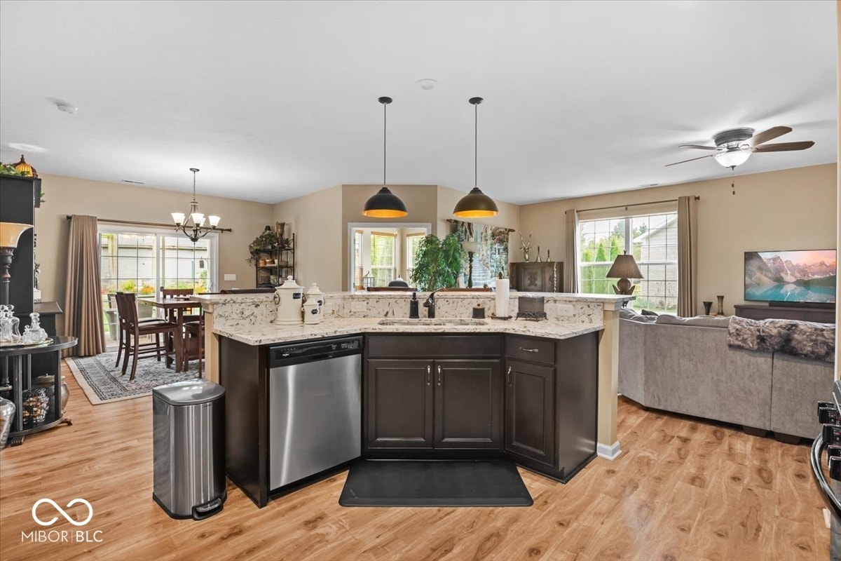 Kitchen island is heart of the home, overlooks the gathering spaces and sink view of the private backyard.