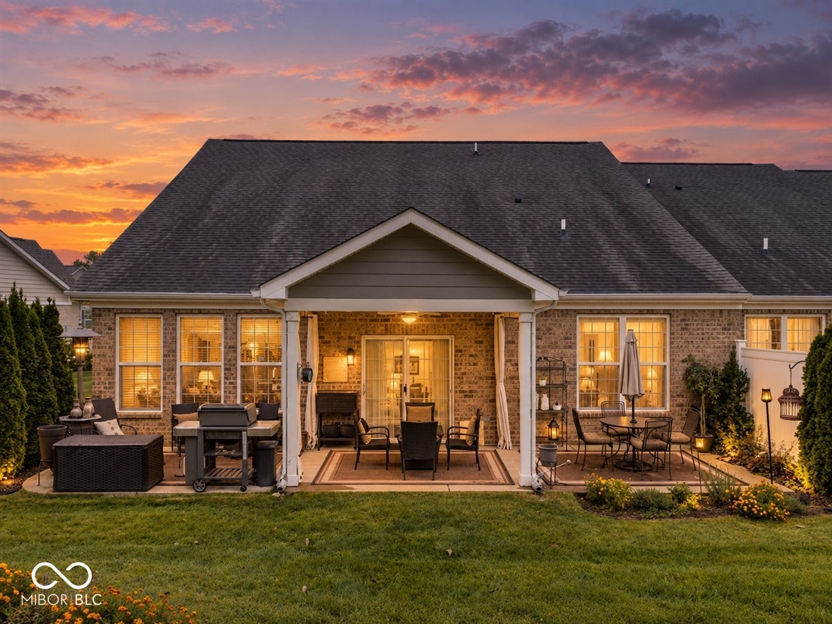 Extended patio on both sides to the full width of the home, added irrigation system, ceiling fan in the covered patio, gorgeous established landscape, room for couch, table, grill - all of it. The patio is large and is both covered and uncovered.