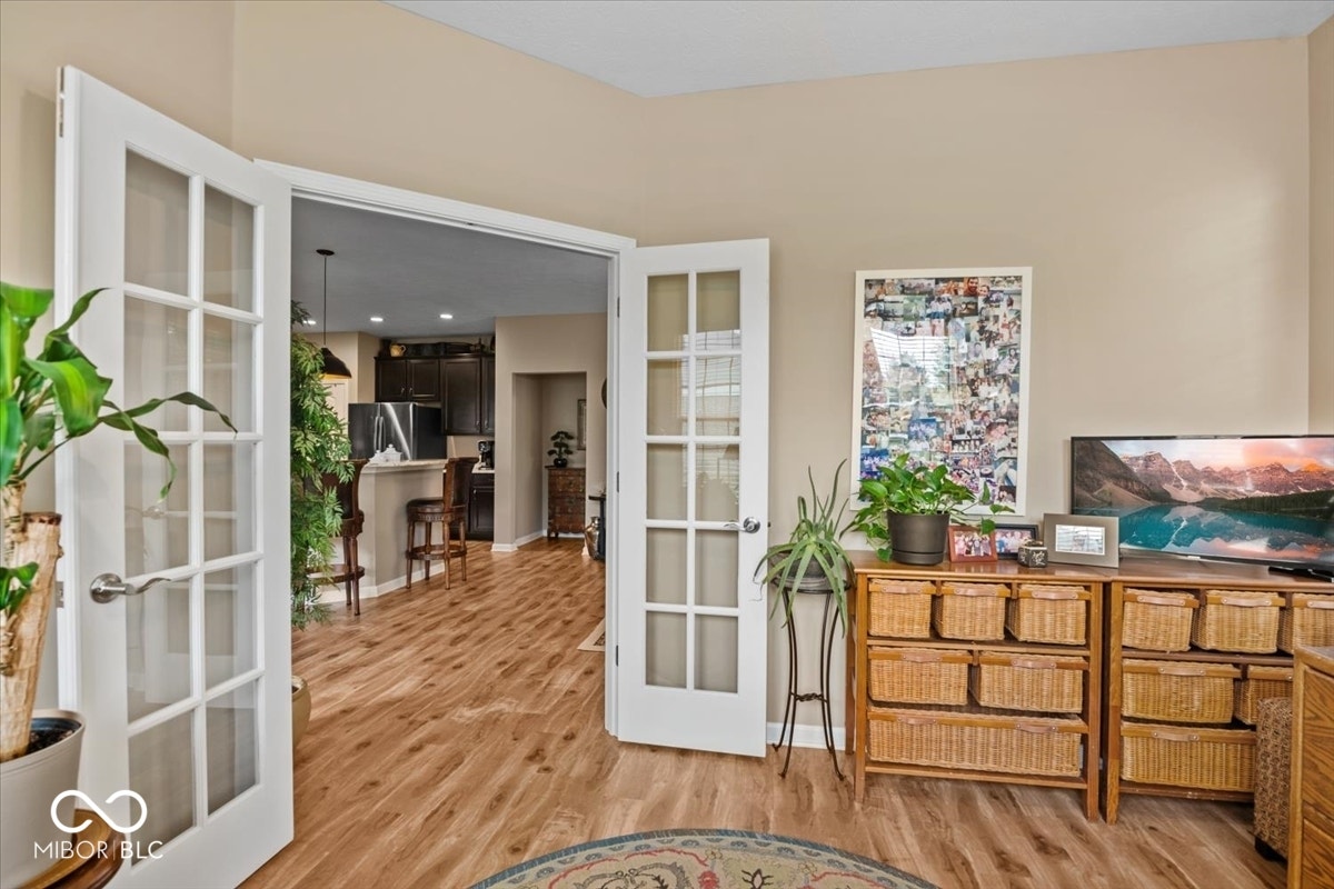 Dedicated Office w/ glass French doors & double wall of windows overlooking backyard