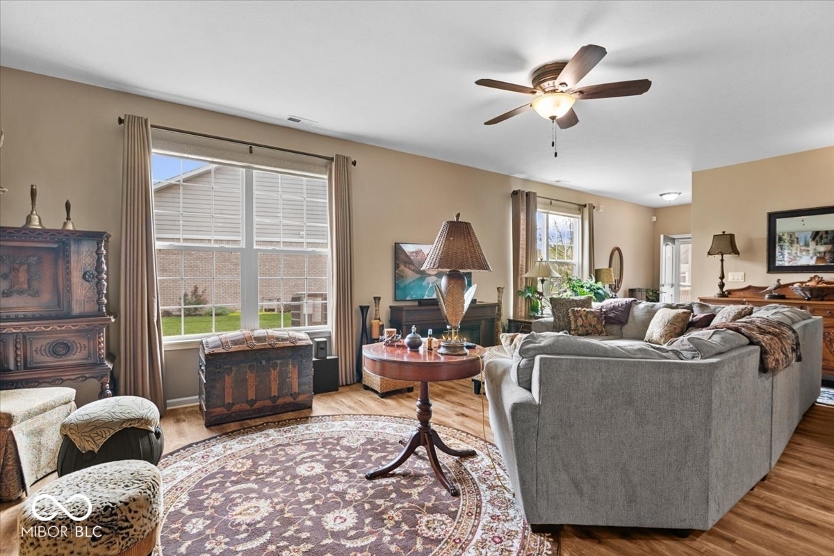 Custom window treatments throughout, 9 ft ceilings, great natural light, neutral/timeless flooring in excellent condition