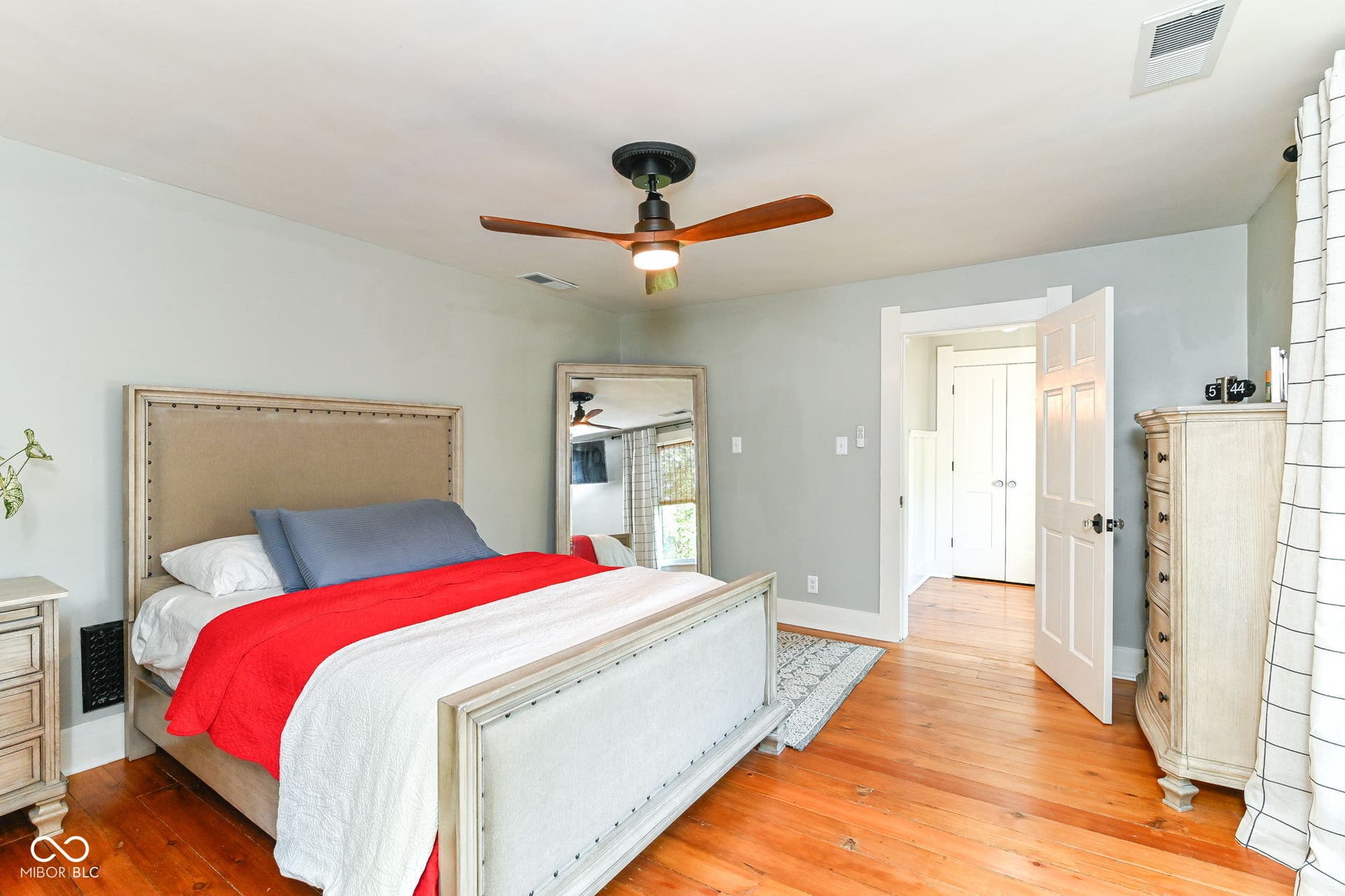Spacious bedroom offers original pine floors, generous proportions, ceiling fan and room for substantial furniture.