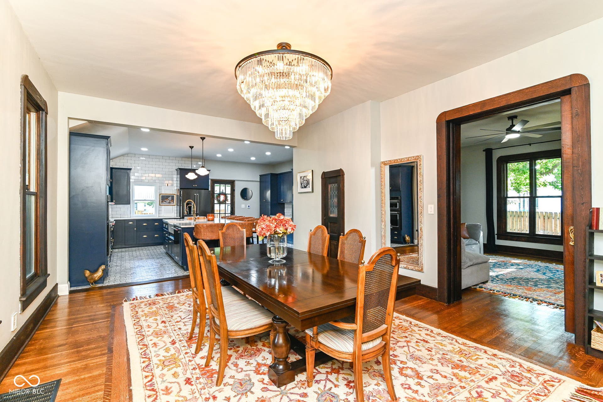 Grand dining room opens directly to the renovated kitchen, blending historic hardwood floors, oversized trim and modern open-concept flow.