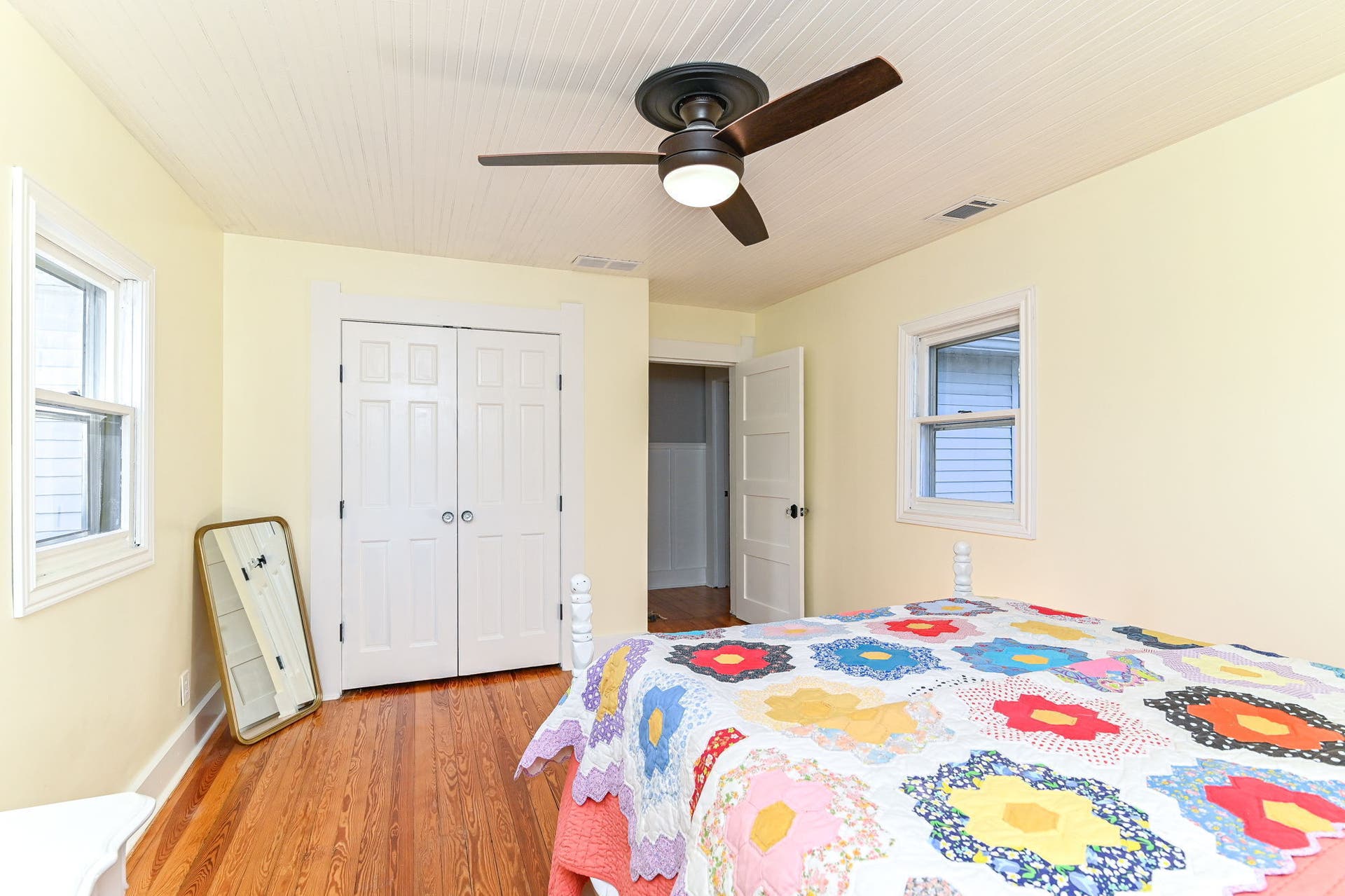 Additional bedroom offers original wood floors, generous closet storage and flexible space for guests, office or hobbies.