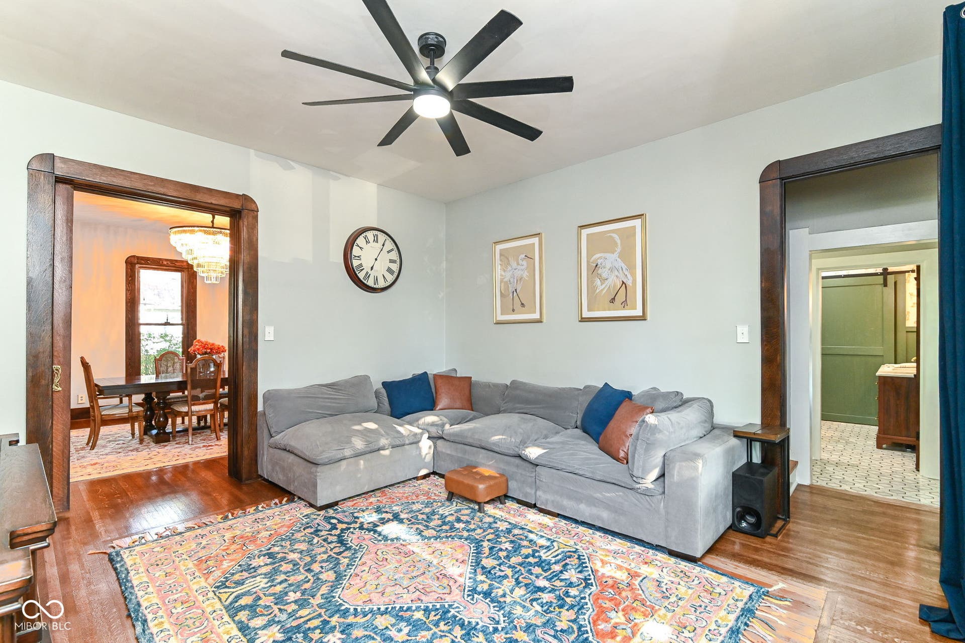 Comfortable living space connects beautifully to the dining area while preserving original trim, tall ceilings and historic character.