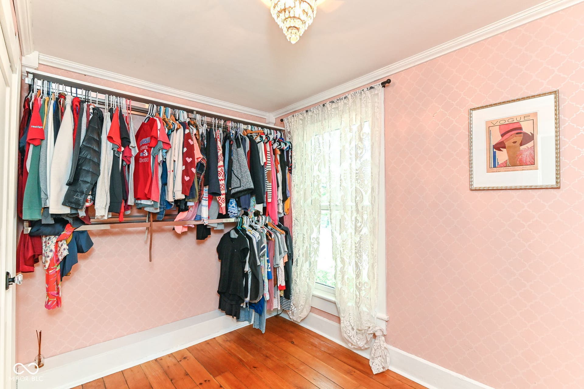 Custom closet system maximizes storage while keeping the home's charming original wood floors and trim on display.