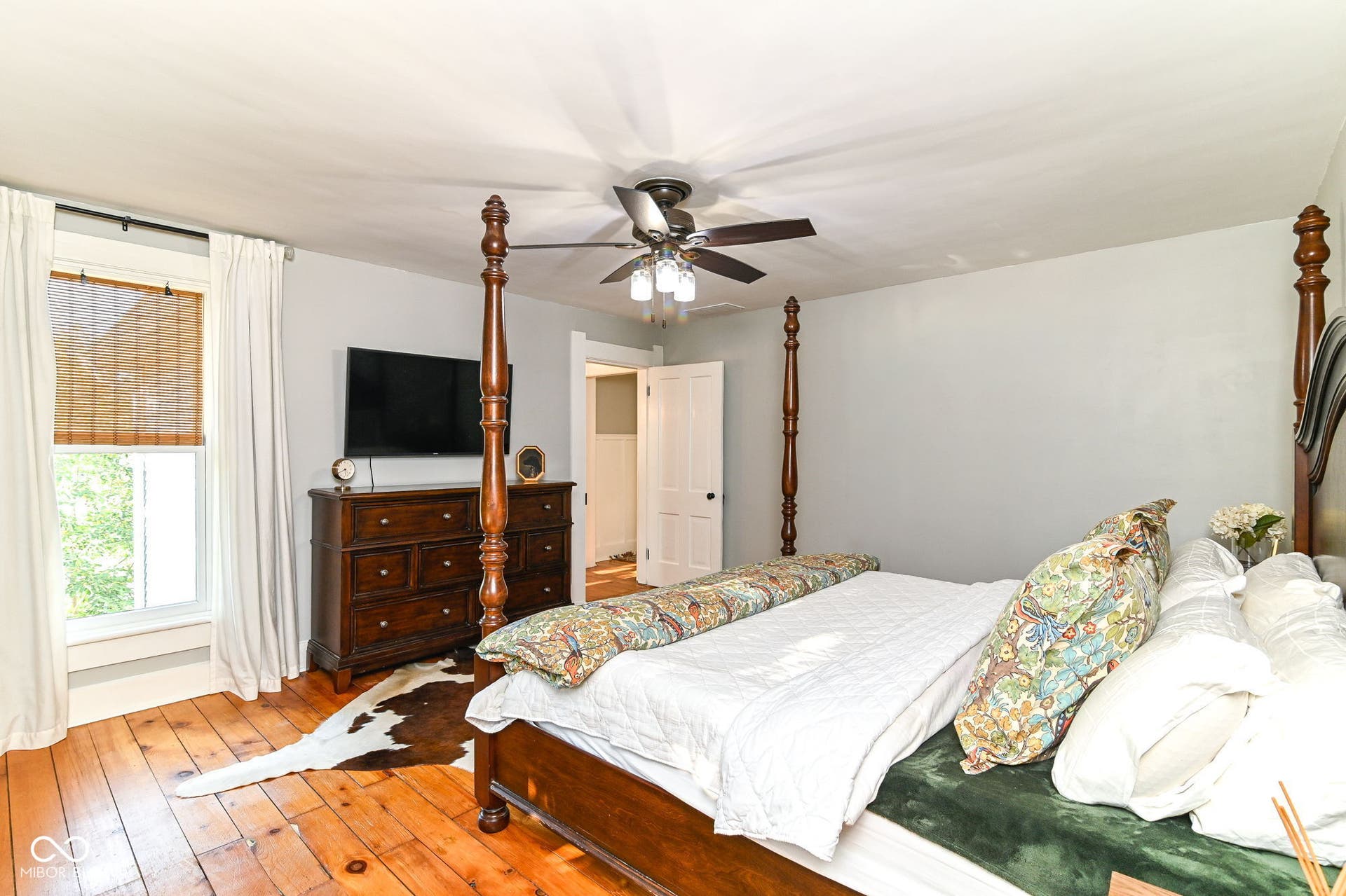 Historic character continues upstairs with original pine flooring, classic trim and flexible bedroom space.