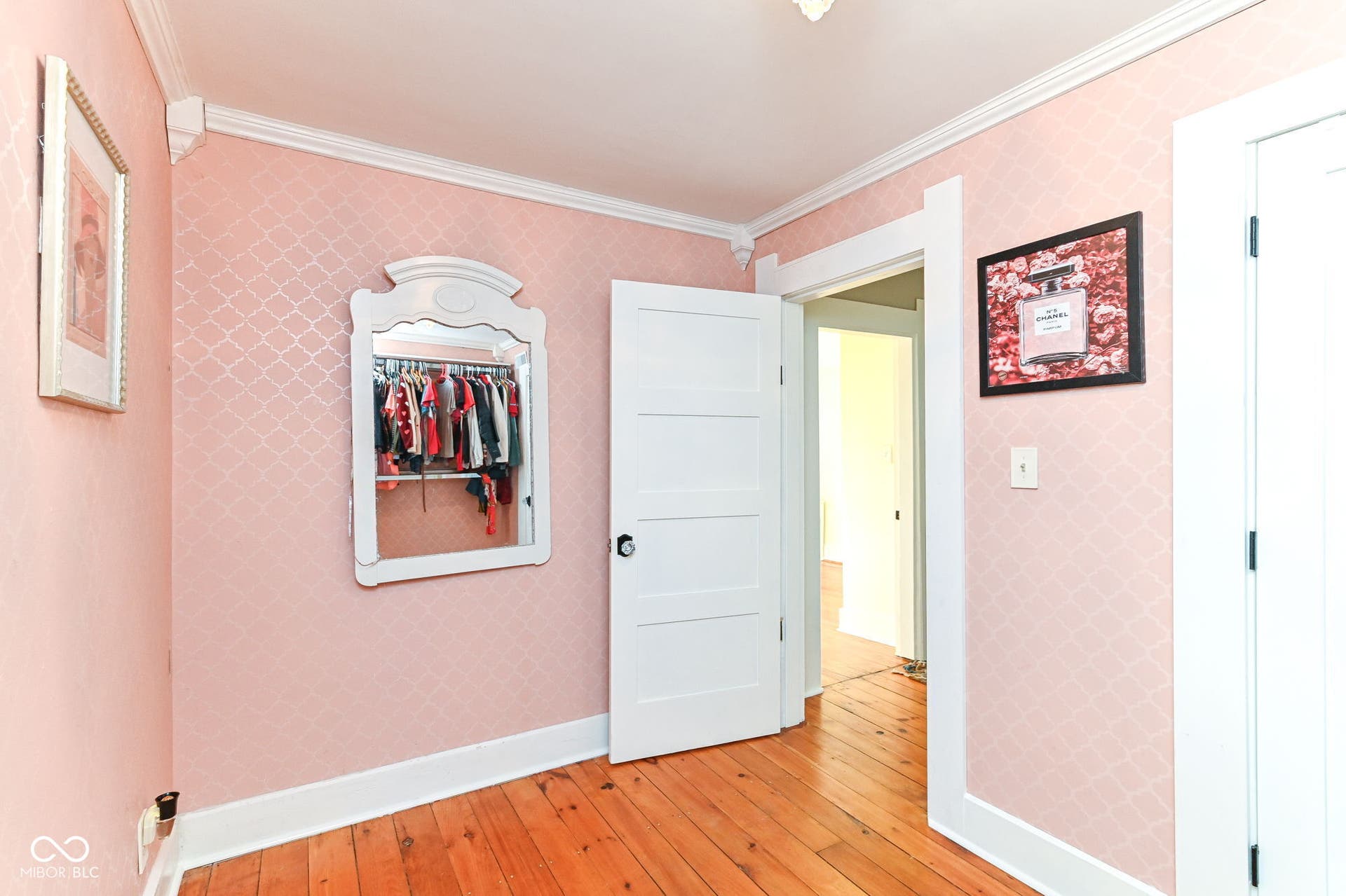 Another view of the flexible upstairs room highlights original floors, classic trim and convenient closet storage.