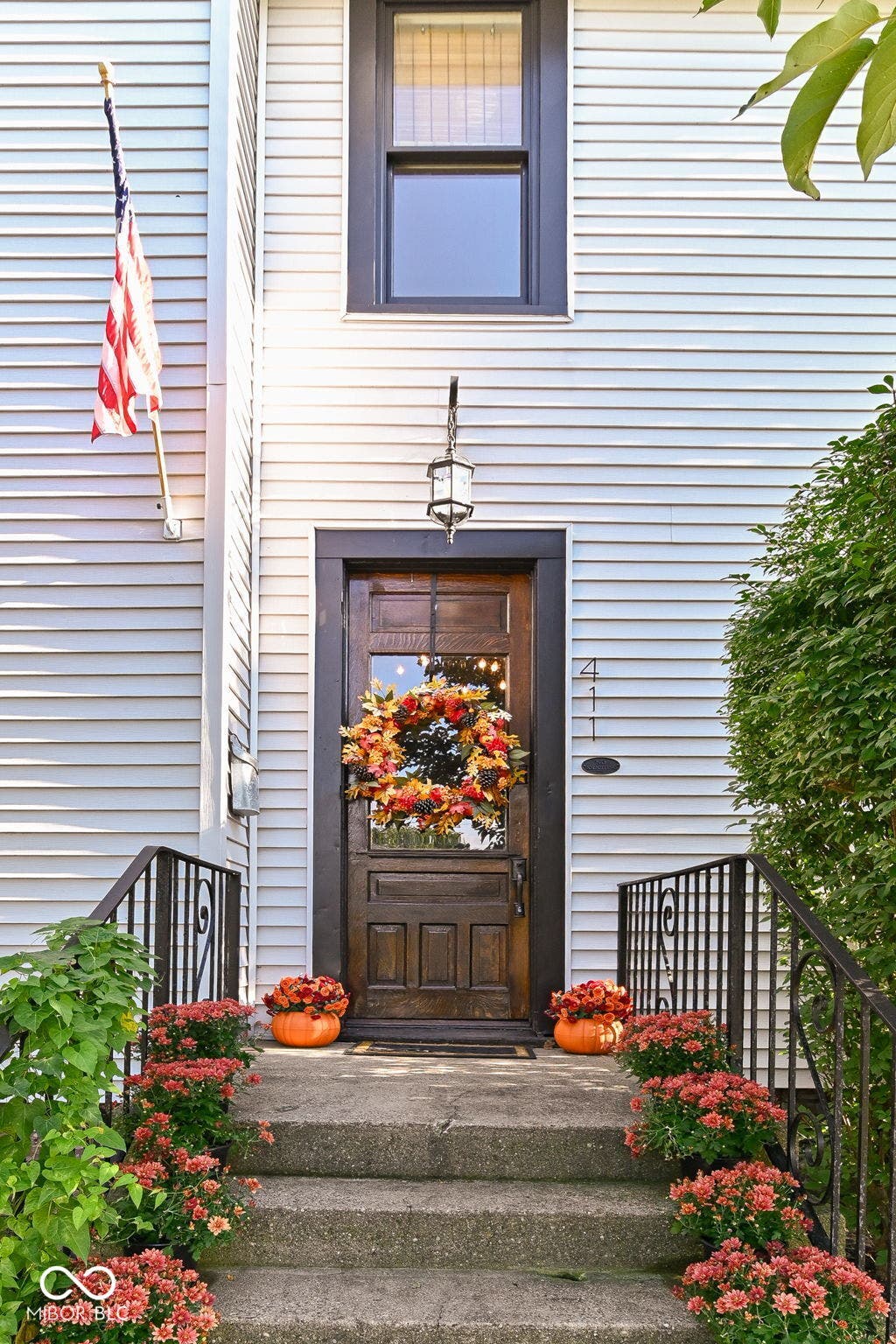 Welcome home through the original front door, framed by classic architectural details and an inviting front entry.