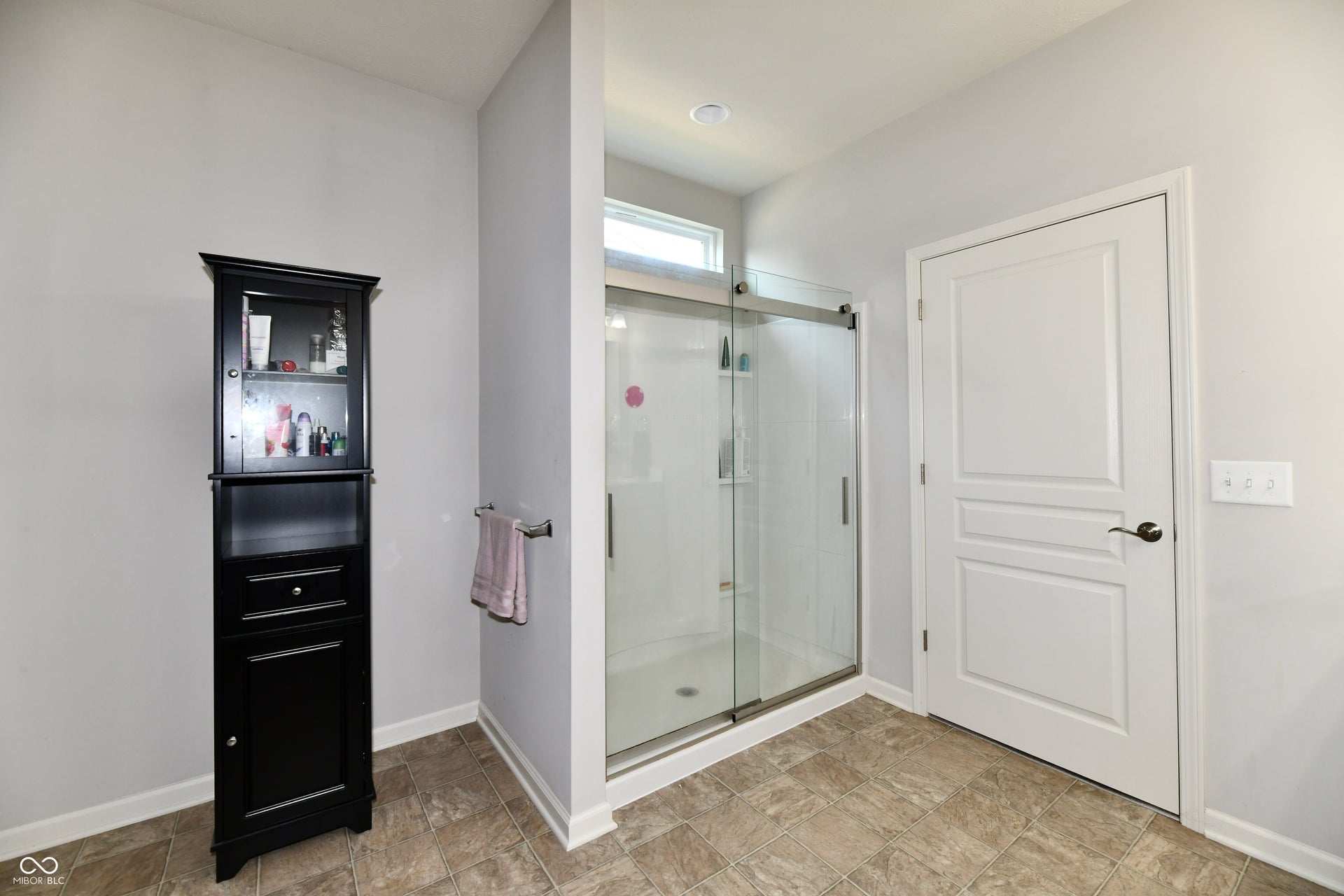 Large shower with glass front rolling doors