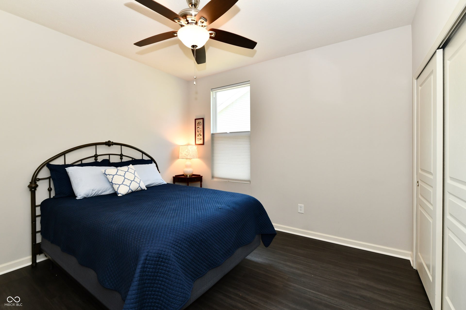 White baseboards and LVP flooring complete the second bedroom