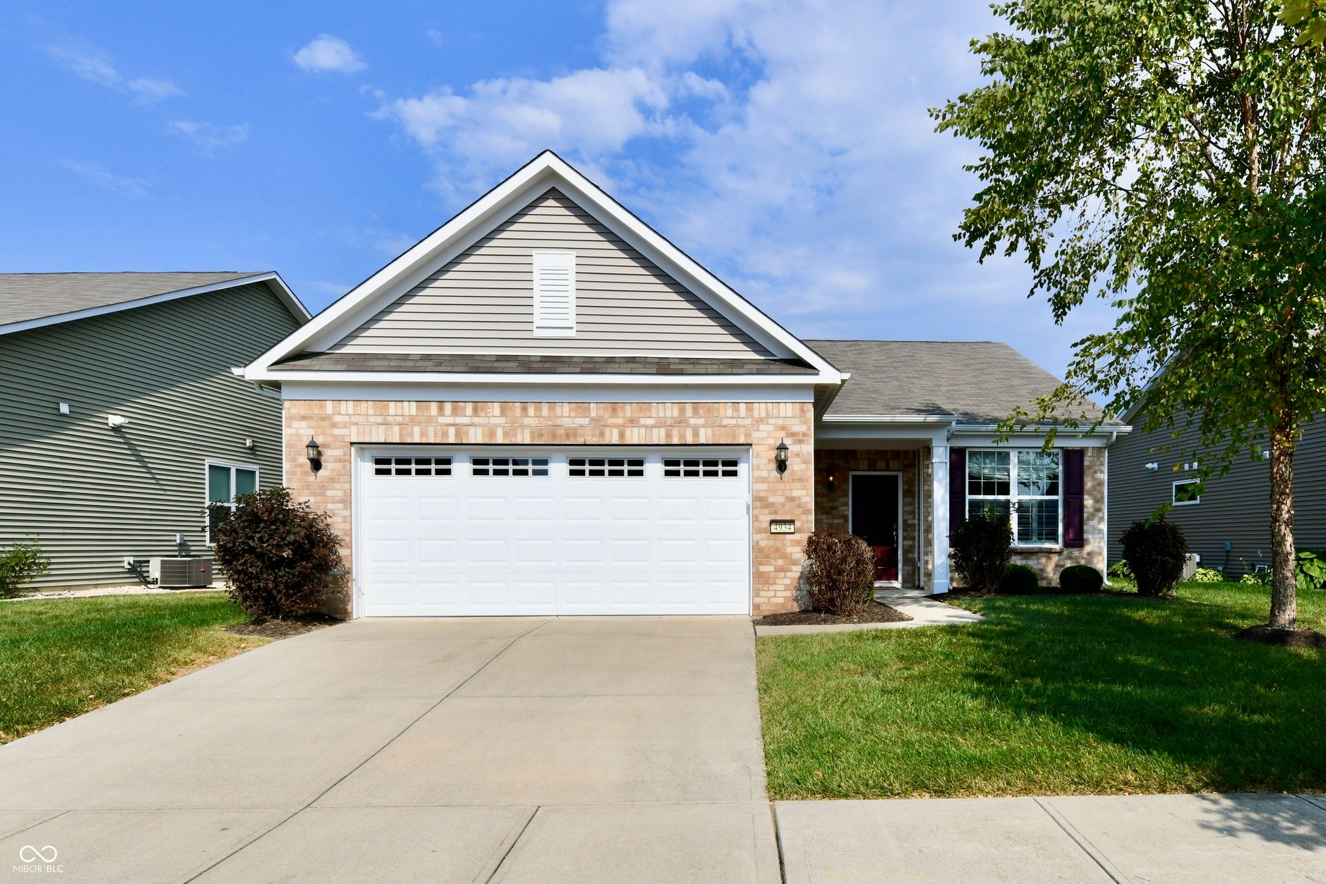 Brick and siding exterior with an attached two-car garage