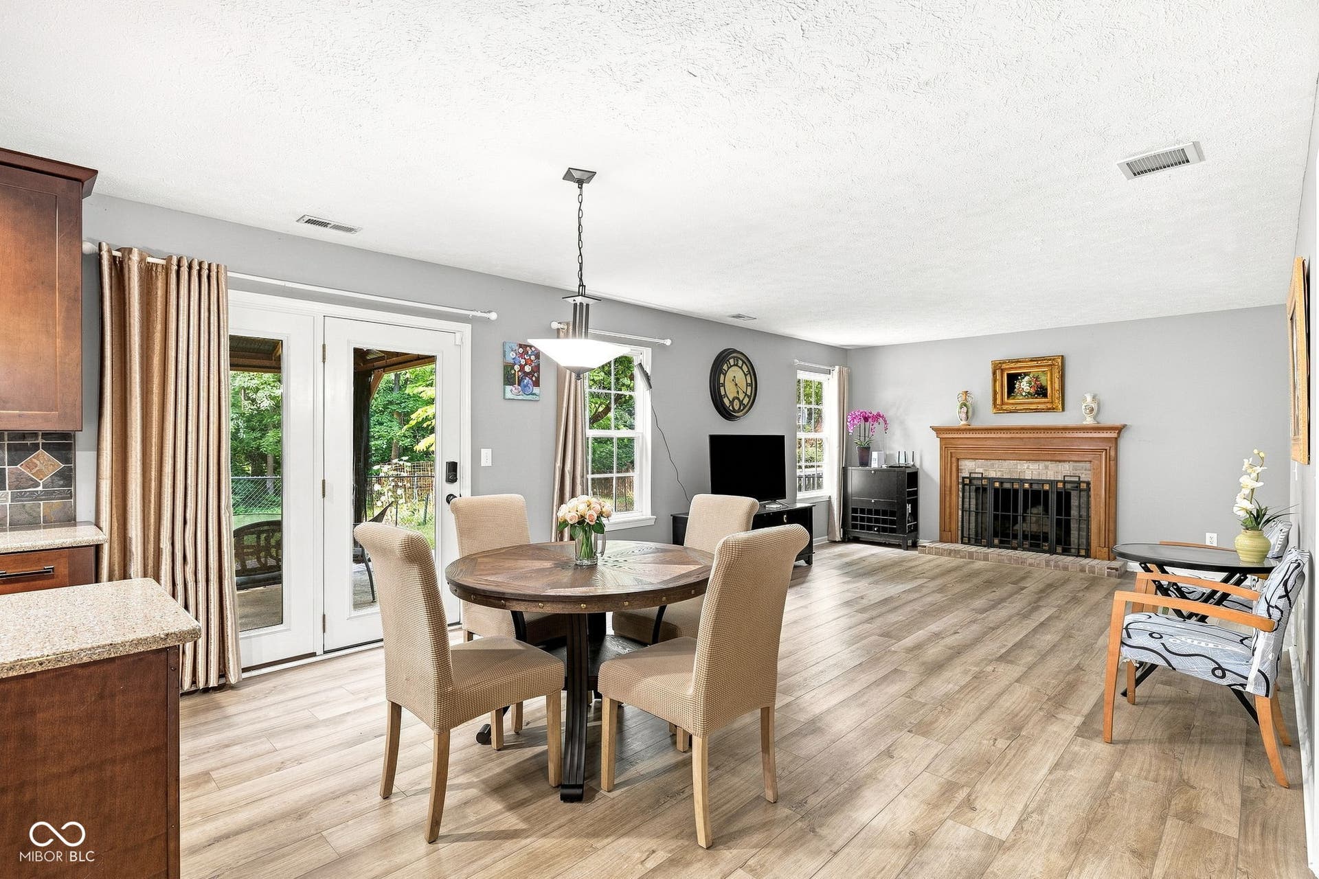 Open concept kitchen, breakfast nook, and family room with patio doors to backyard gazebo
