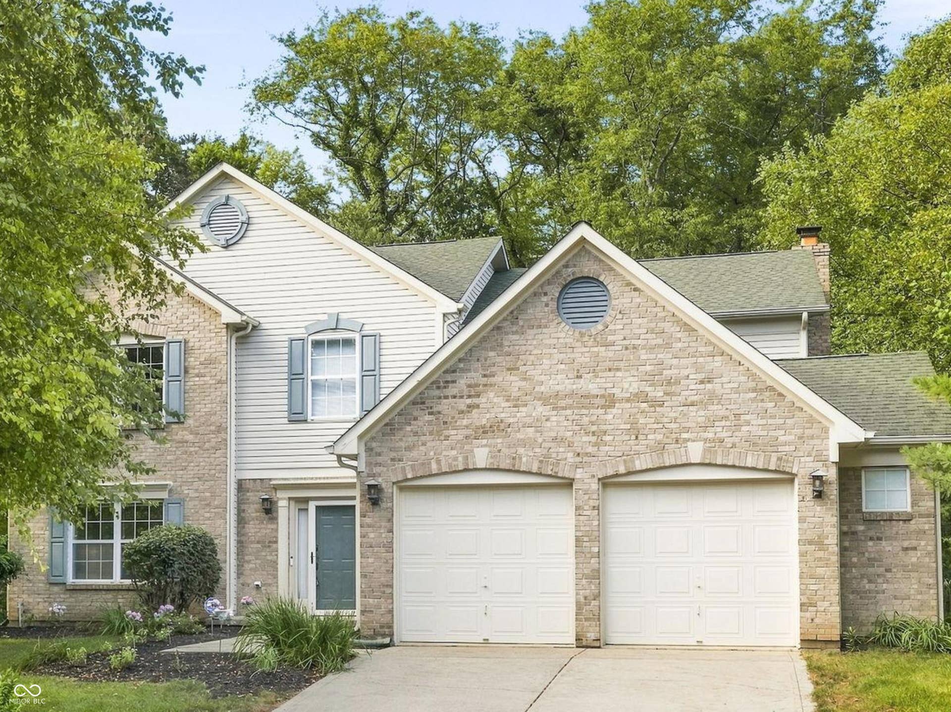 Timeless Traditional American two story with two car garage and 4 ft bump out for storage.
