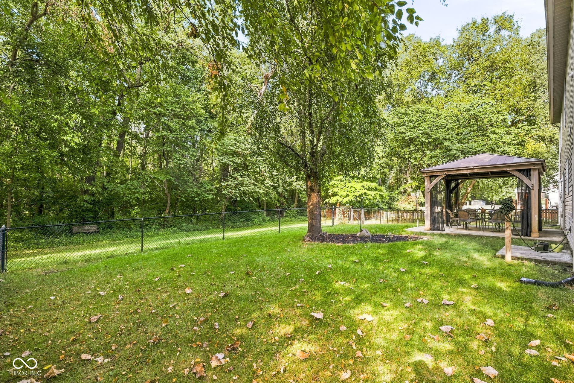 Full fenced rear yard and view of 6 acre woods