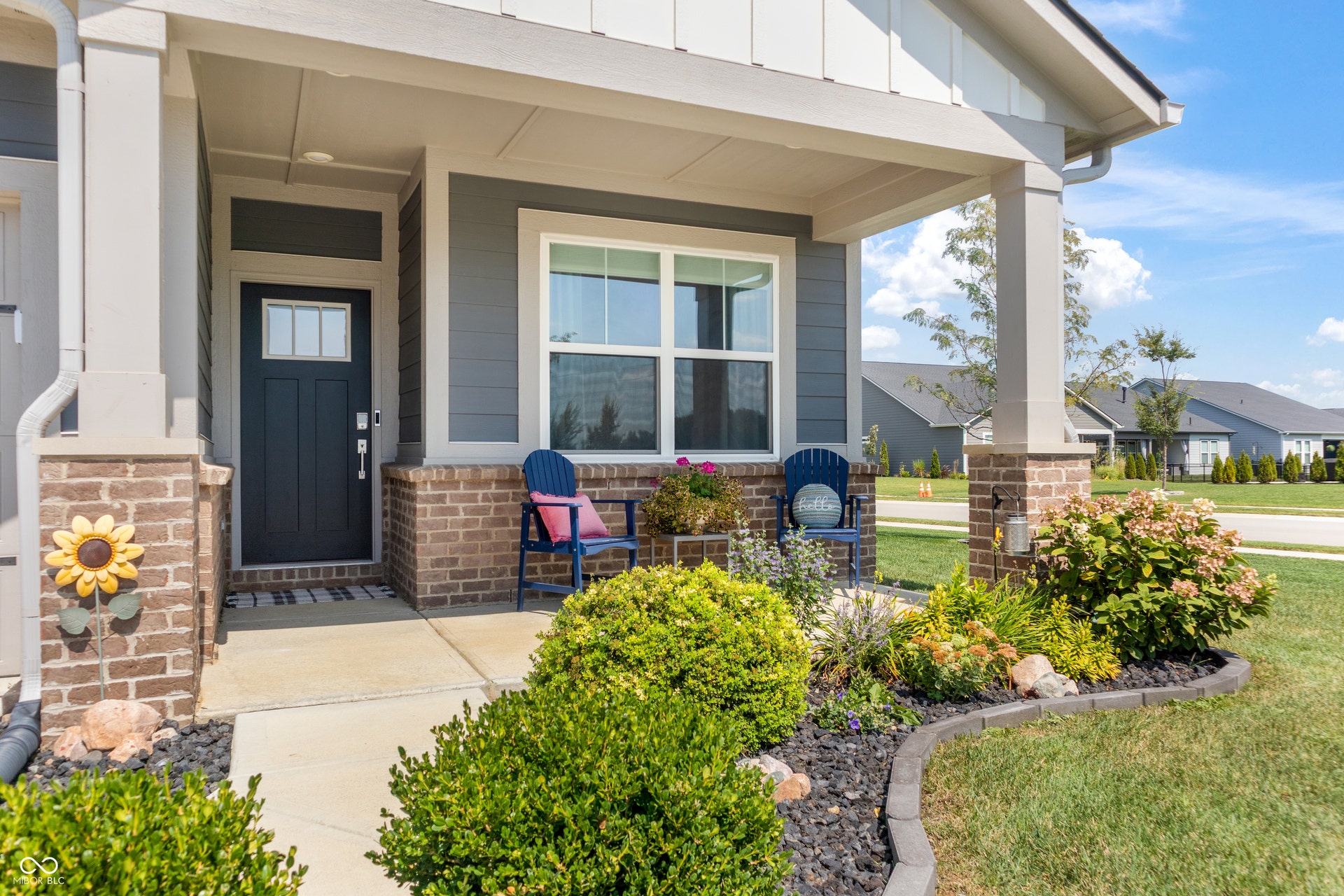 Covered porch with tastefully manicured landscaping!