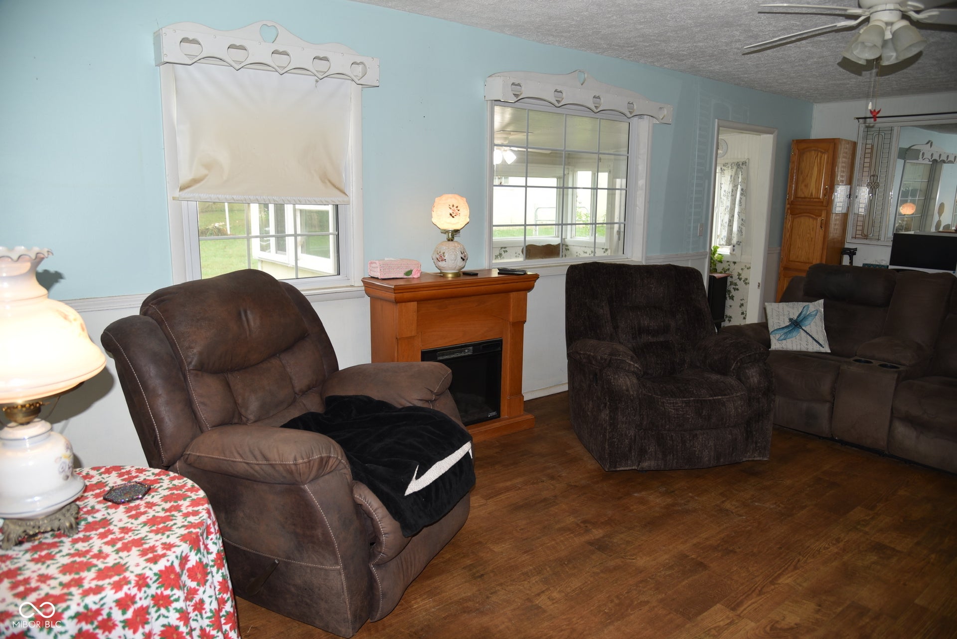 Wood-finish flooring throughout, light blue wall paint, and white trim