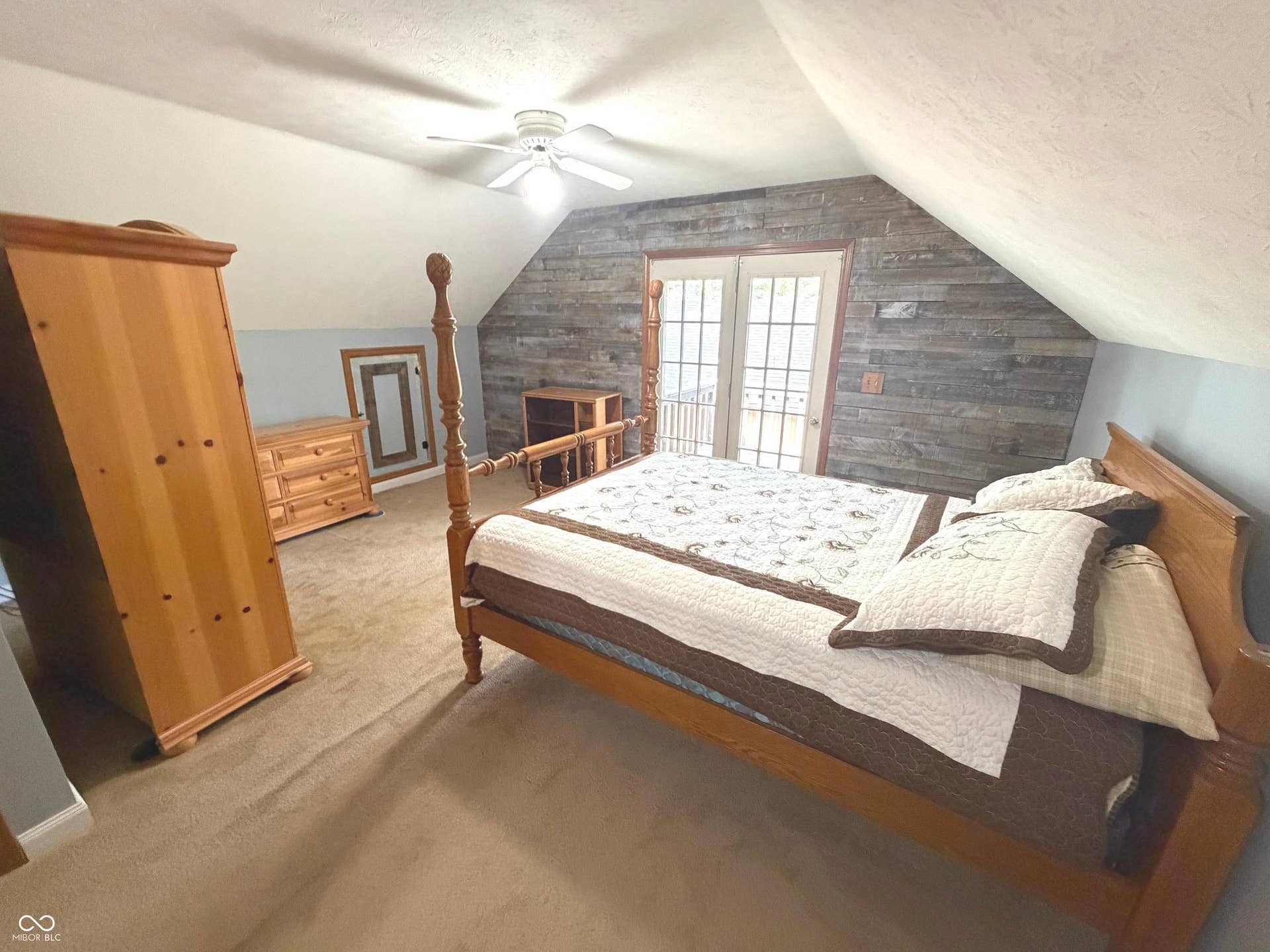 Primary Bedroom upstairs with ceiling fan, walk-out deck, full bath with tub/shower combo and large walk-in closet.