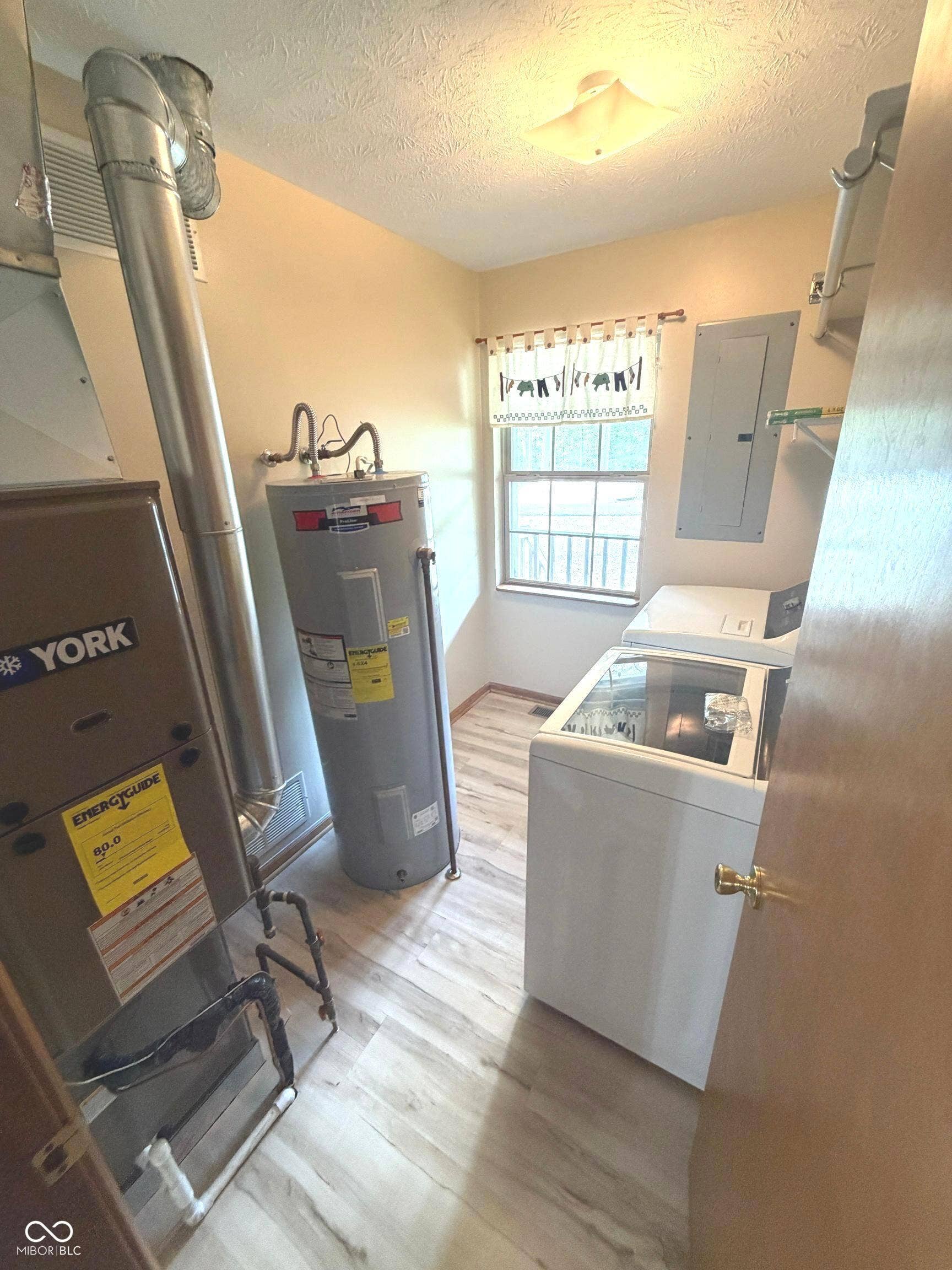 Laundry Room on Main with 200 amp panel, newer gas furnace and electric water heater.  Washer and dryer are not included.