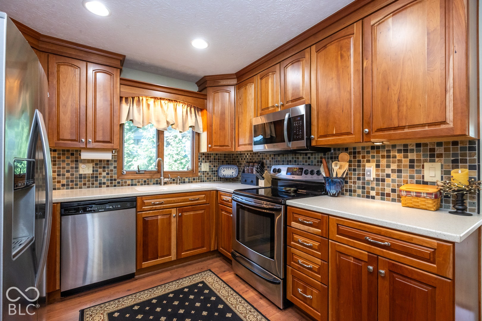 updated kitchen with SS appliances, hardwood floors and cherry cabinets.