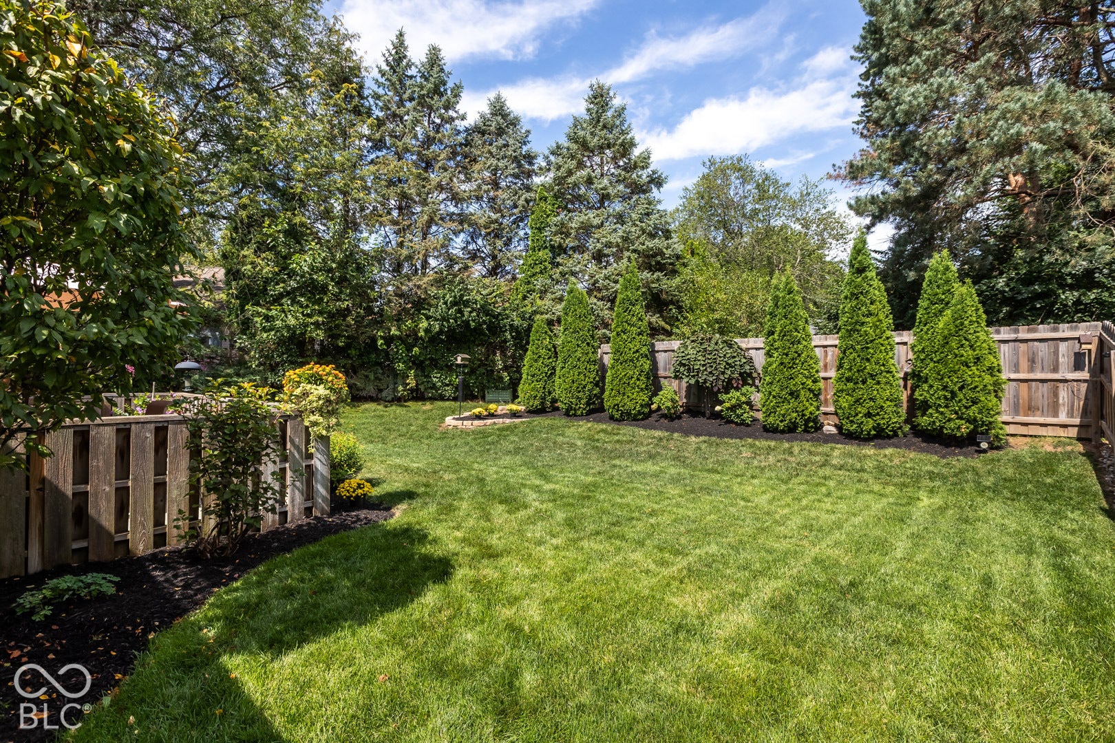 extremely private fully fenced rear yard with deck.