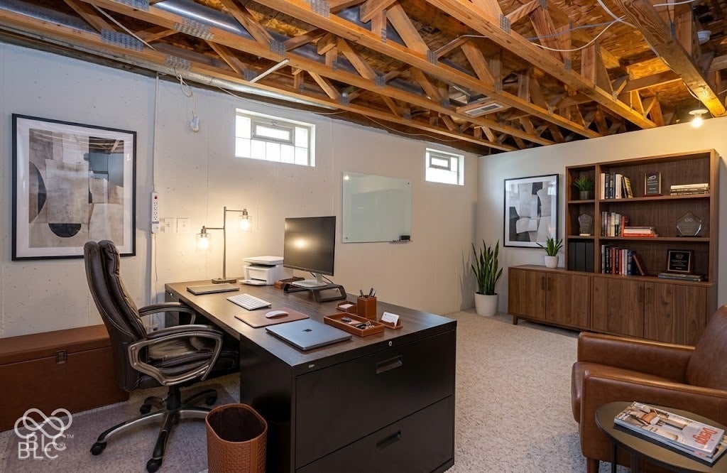 Virtually Altered - Exposed wood beam ceiling with recessed lighting, light-colored carpet flooring, white painted walls, and high-set windows
