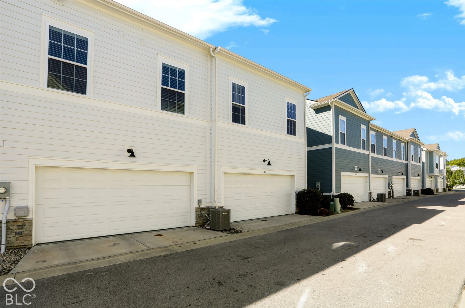 White vinyl siding exterior with an integrated garage