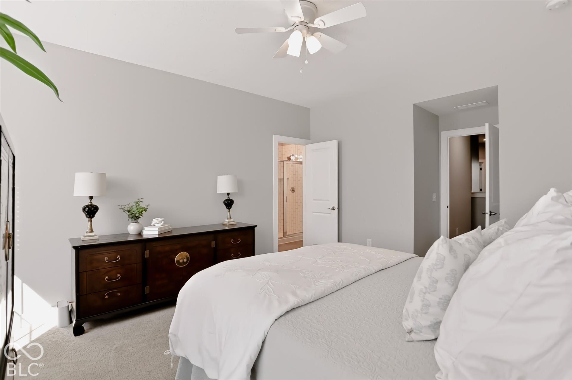 Ceiling fan, neutral wall color, carpet flooring, flat panel interior doors, and a tiled shower stall