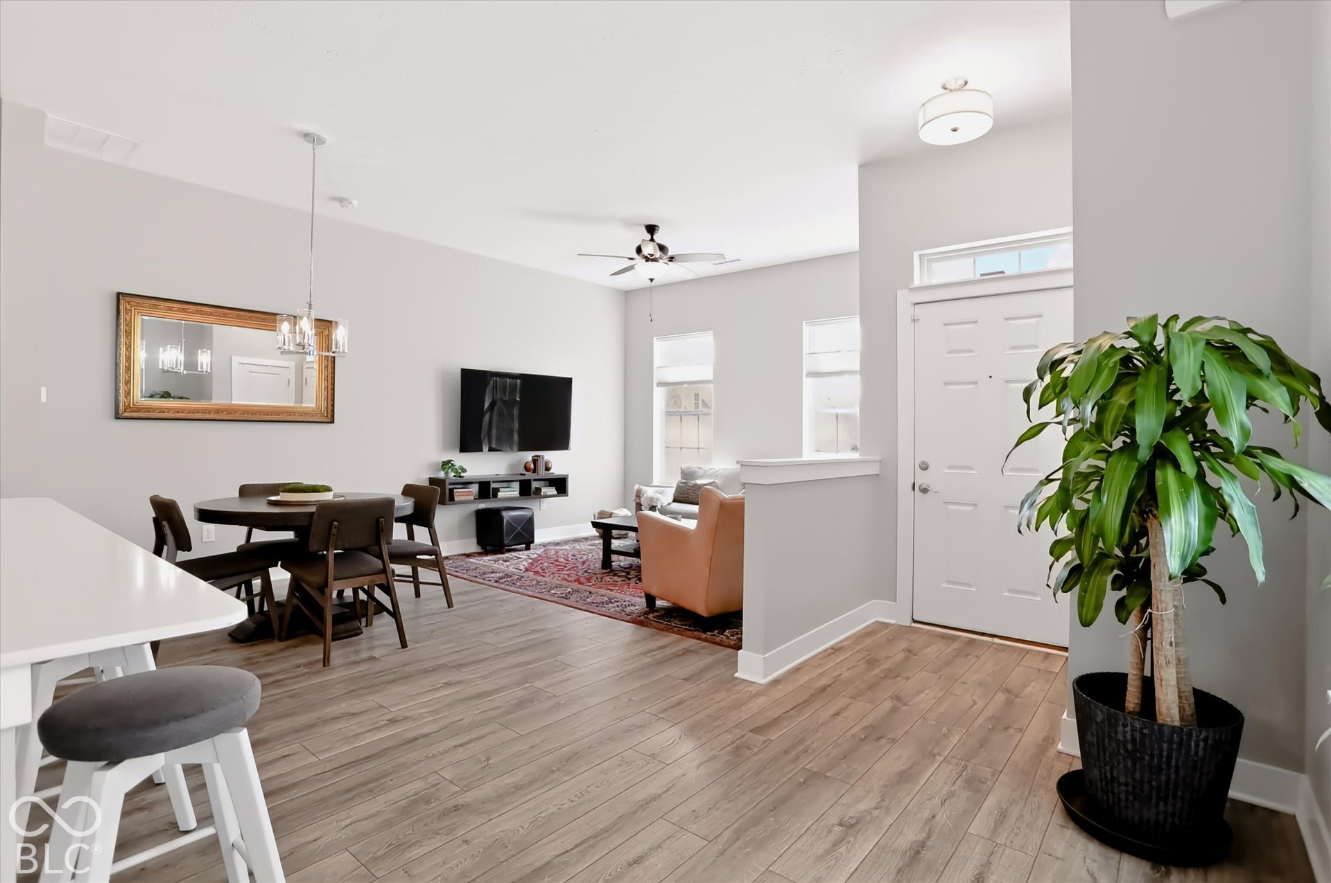 Wood-finish flooring throughout, complemented by light gray wall tones