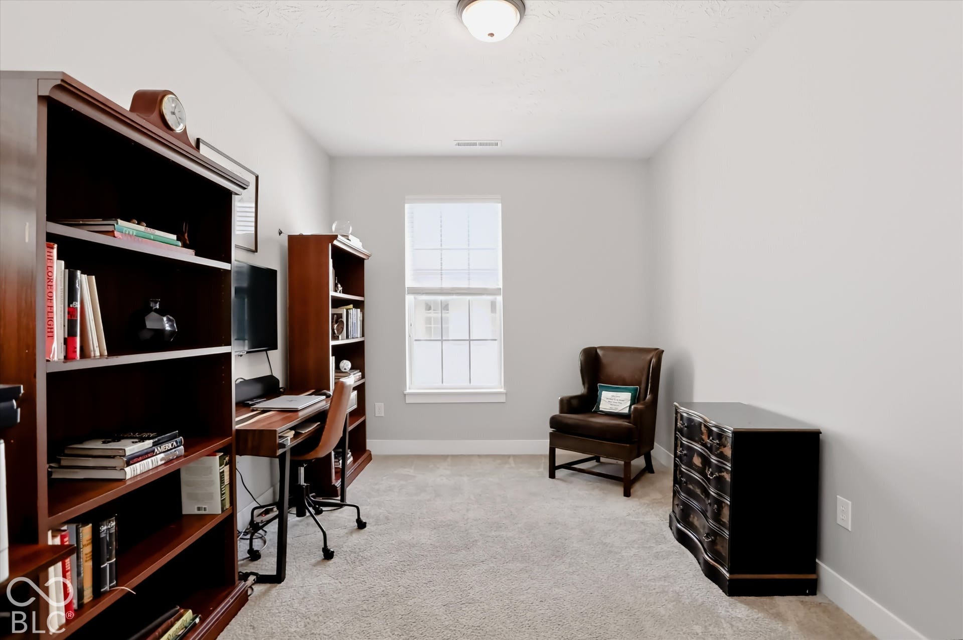 Bedroom 3 currently used as an office. Neutral wall paint throughout