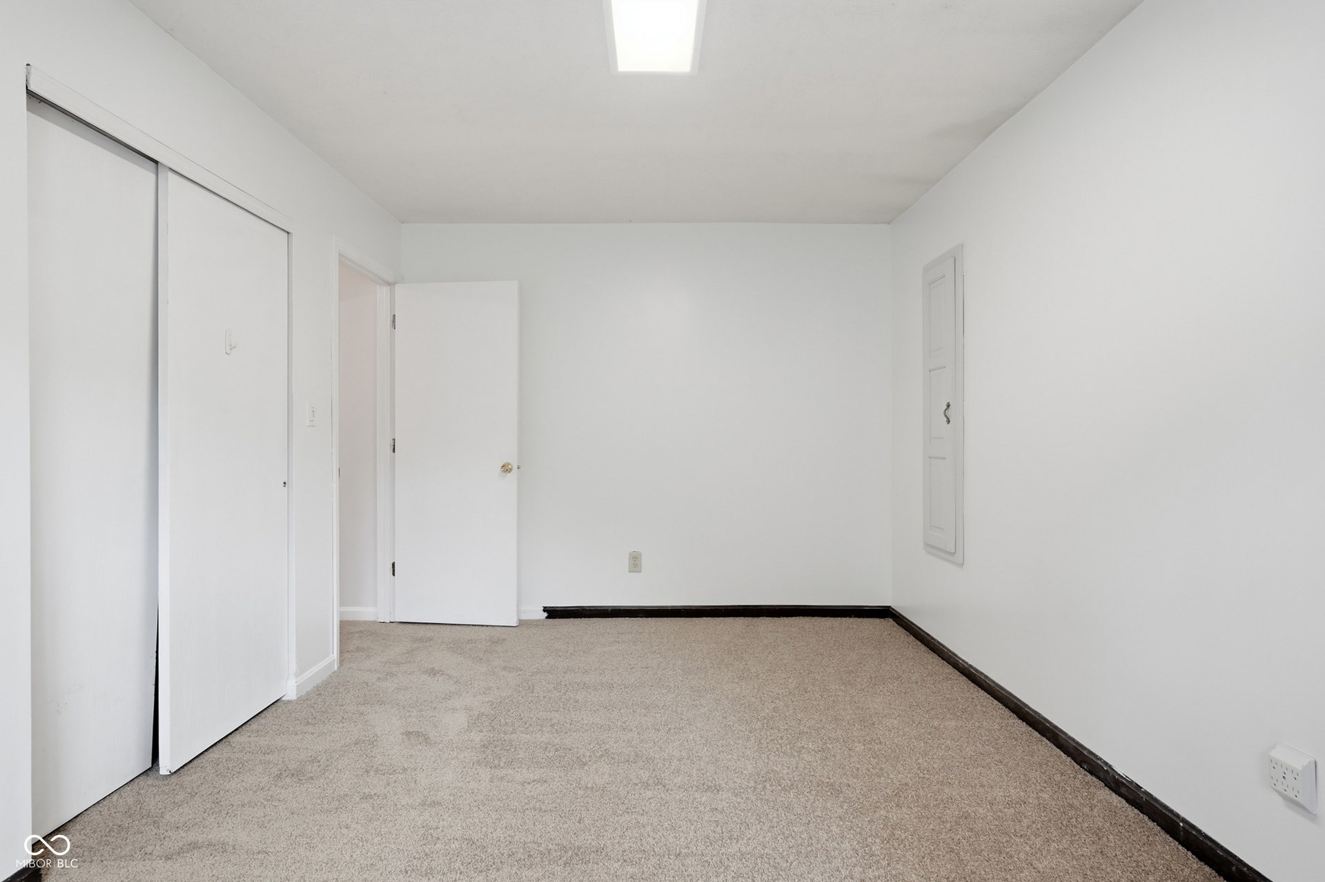7927 Hoop Road, Indianapolis, IN 46217 Upper level bedroom 2, neutral tone wall paint, carpet flooring, and a flush-mount ceiling light fixture