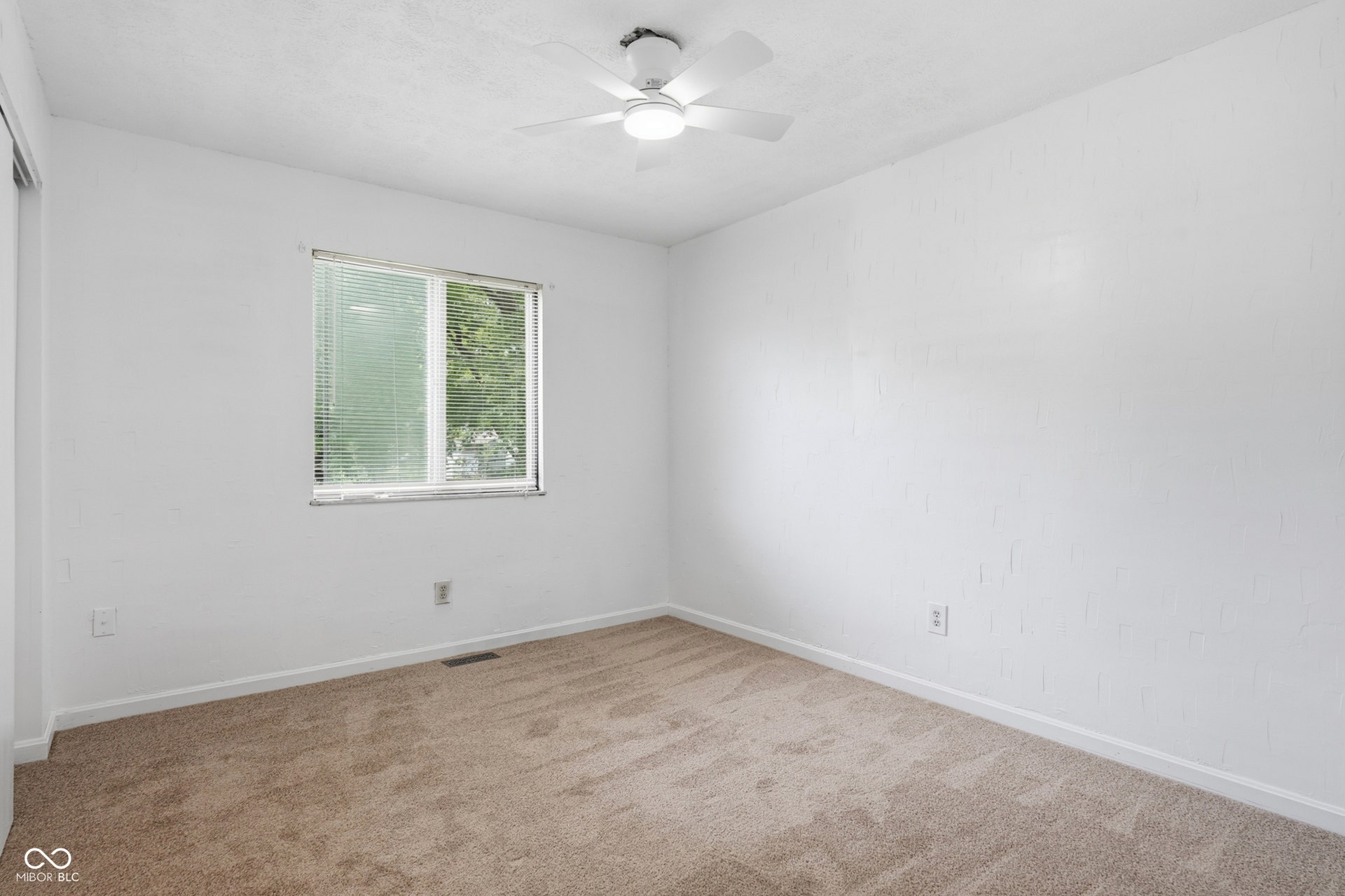 7927 Hoop Road, Indianapolis, IN 46217 Upper level bedroom 3, carpeted flooring, white walls, window with horizontal blinds, and a ceiling fan with integrated lighting