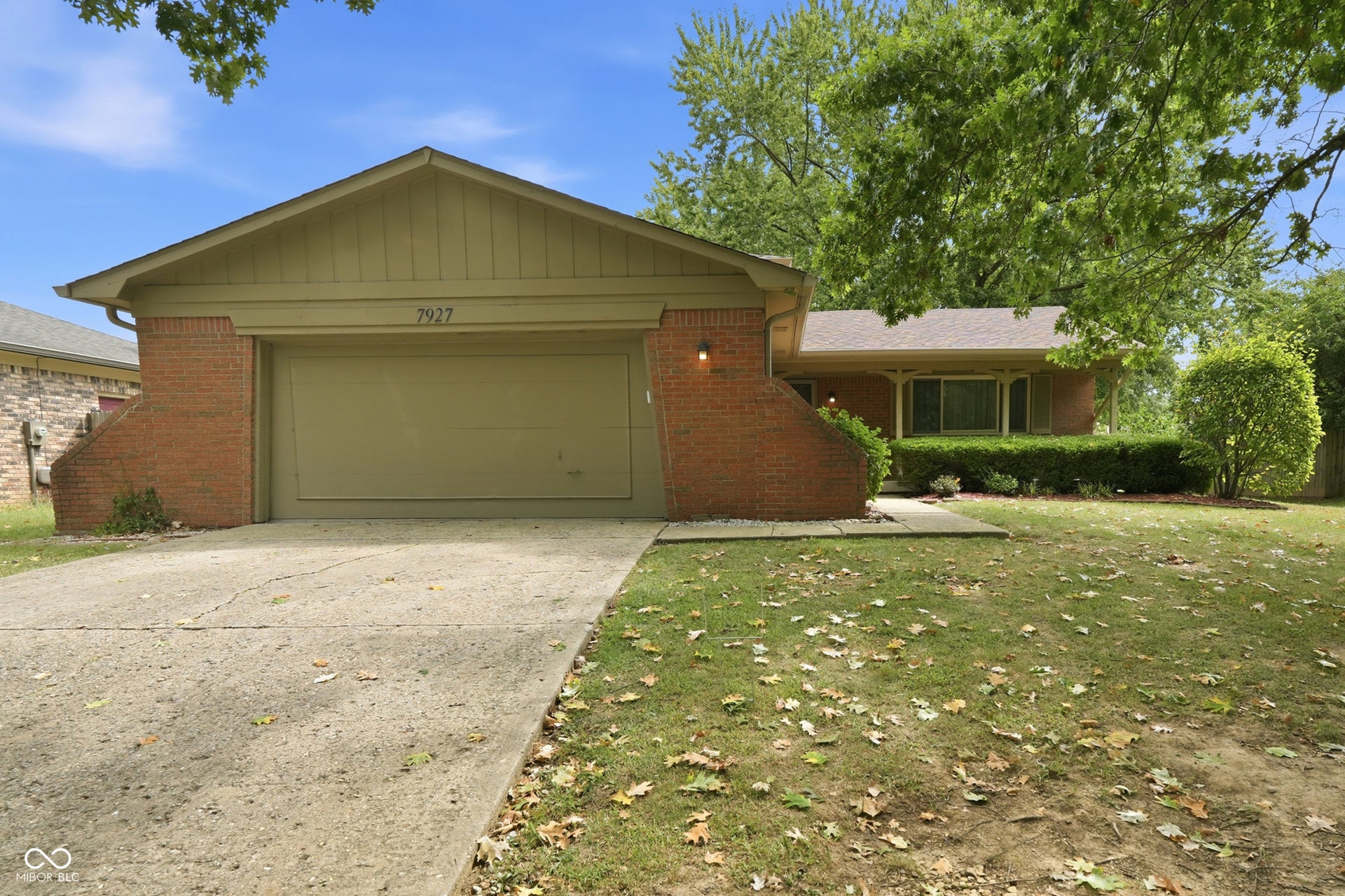 7927 Hoop Road, Indianapolis, IN 46217 Brick facade with a covered entry and a two-car garage