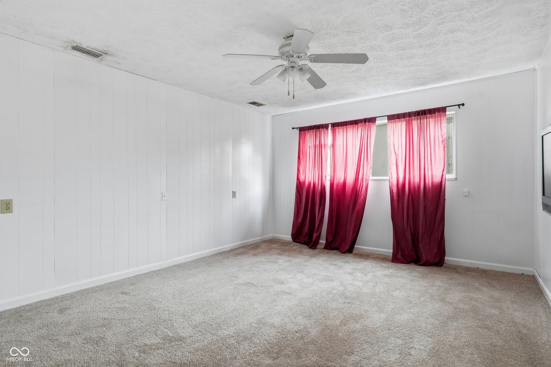 7927 Hoop Road, Indianapolis, IN 46217 Lower level bedroom 4, carpeted flooring, white paneled wall, a window, a ceiling fan, and white walls