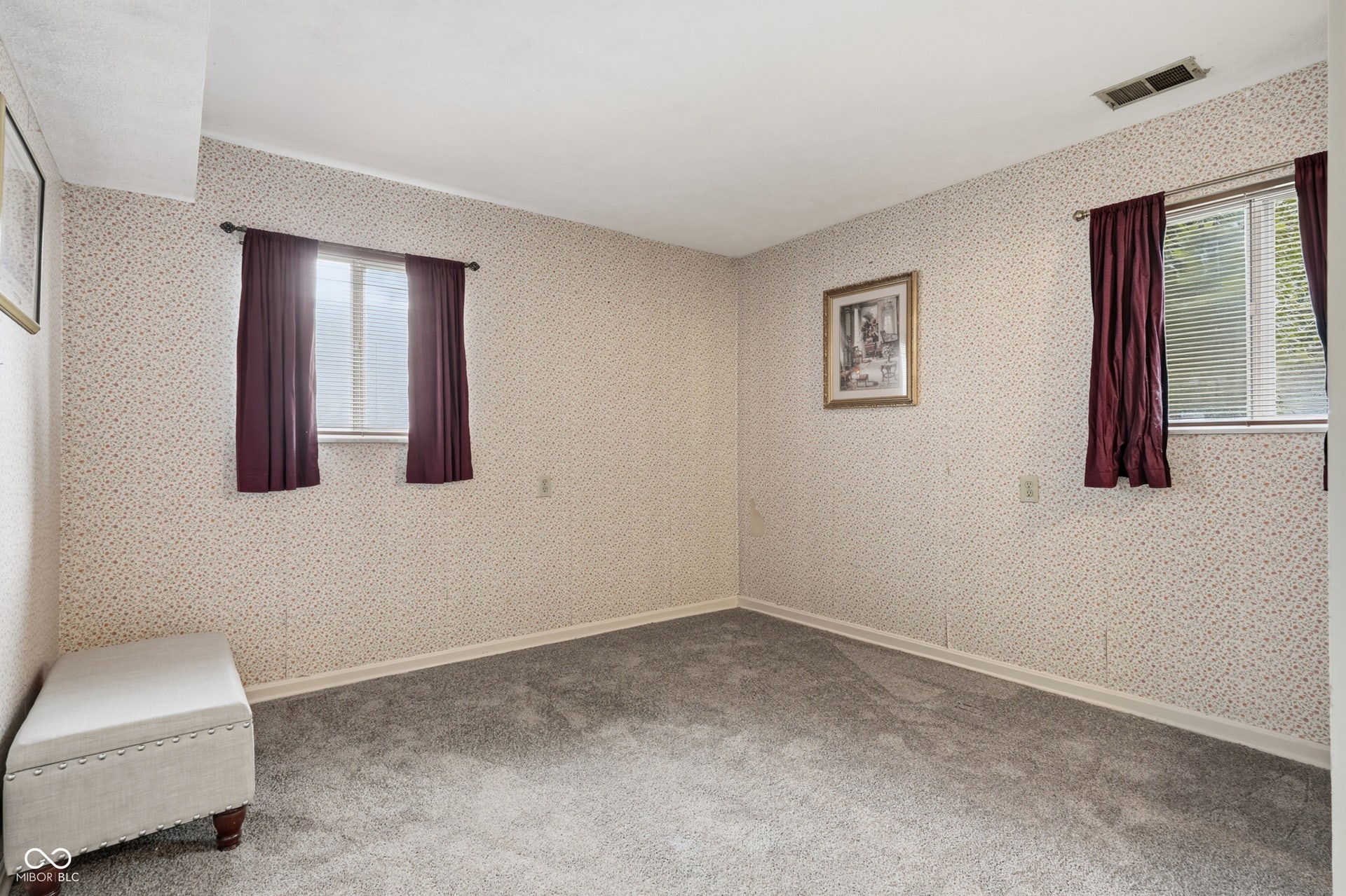 7927 Hoop Road, Indianapolis, IN 46217 Lower level family room/5th bedroom, wall-to-wall carpeting, two windows with blinds, and patterned wallpaper