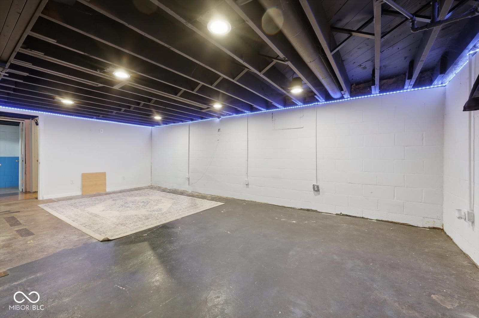 Exposed ceiling with recessed lighting and perimeter accent lighting