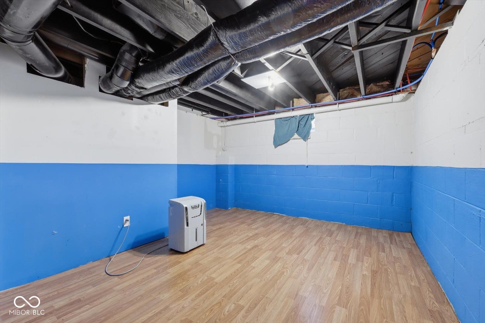 Wood-finish flooring with painted block walls