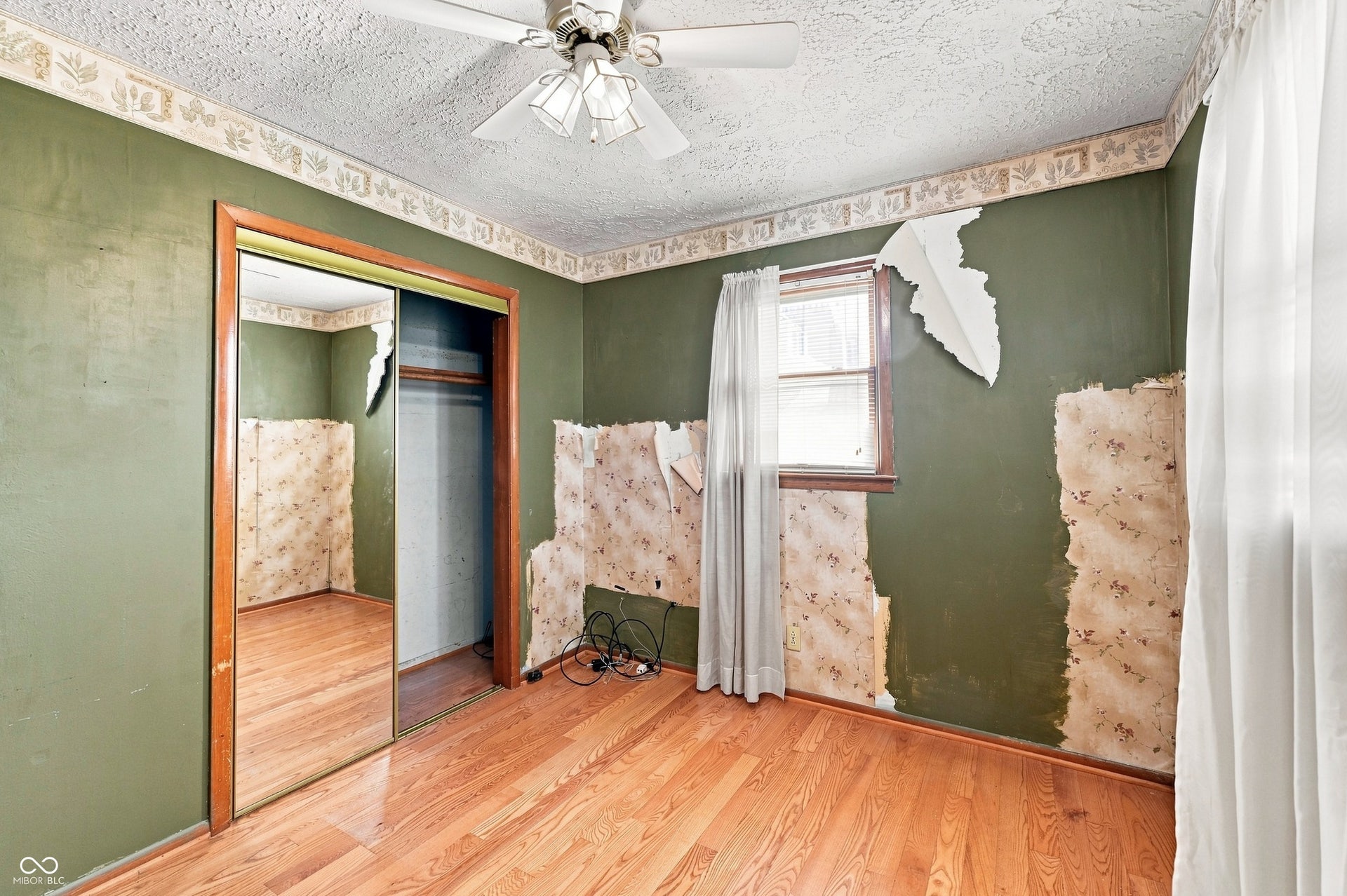 11 x 10 Second Bedroom with hardwood floors.