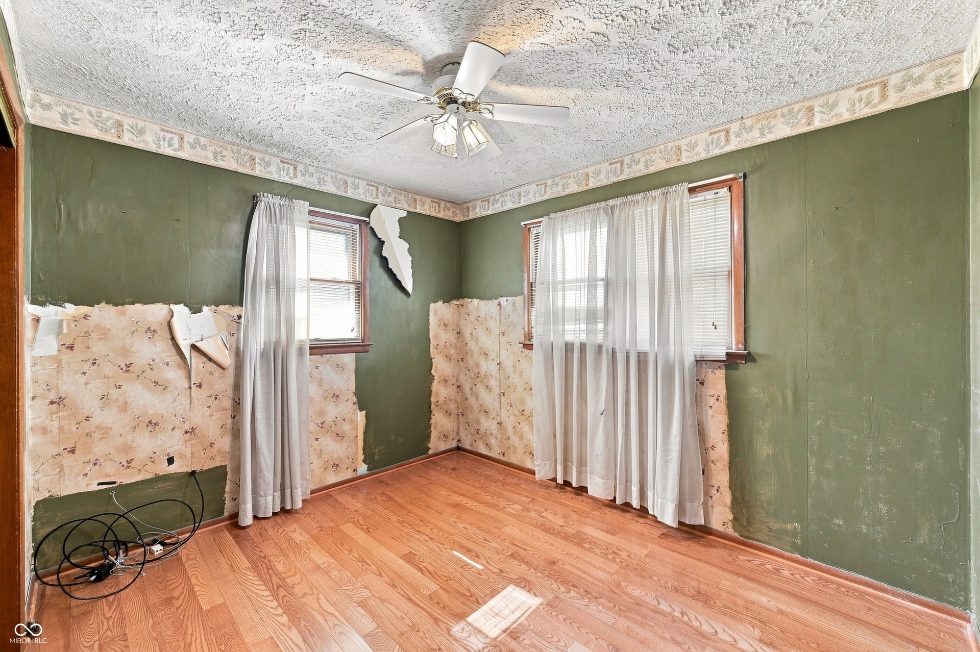 11 x 10 Second Bedroom with hardwood floors.