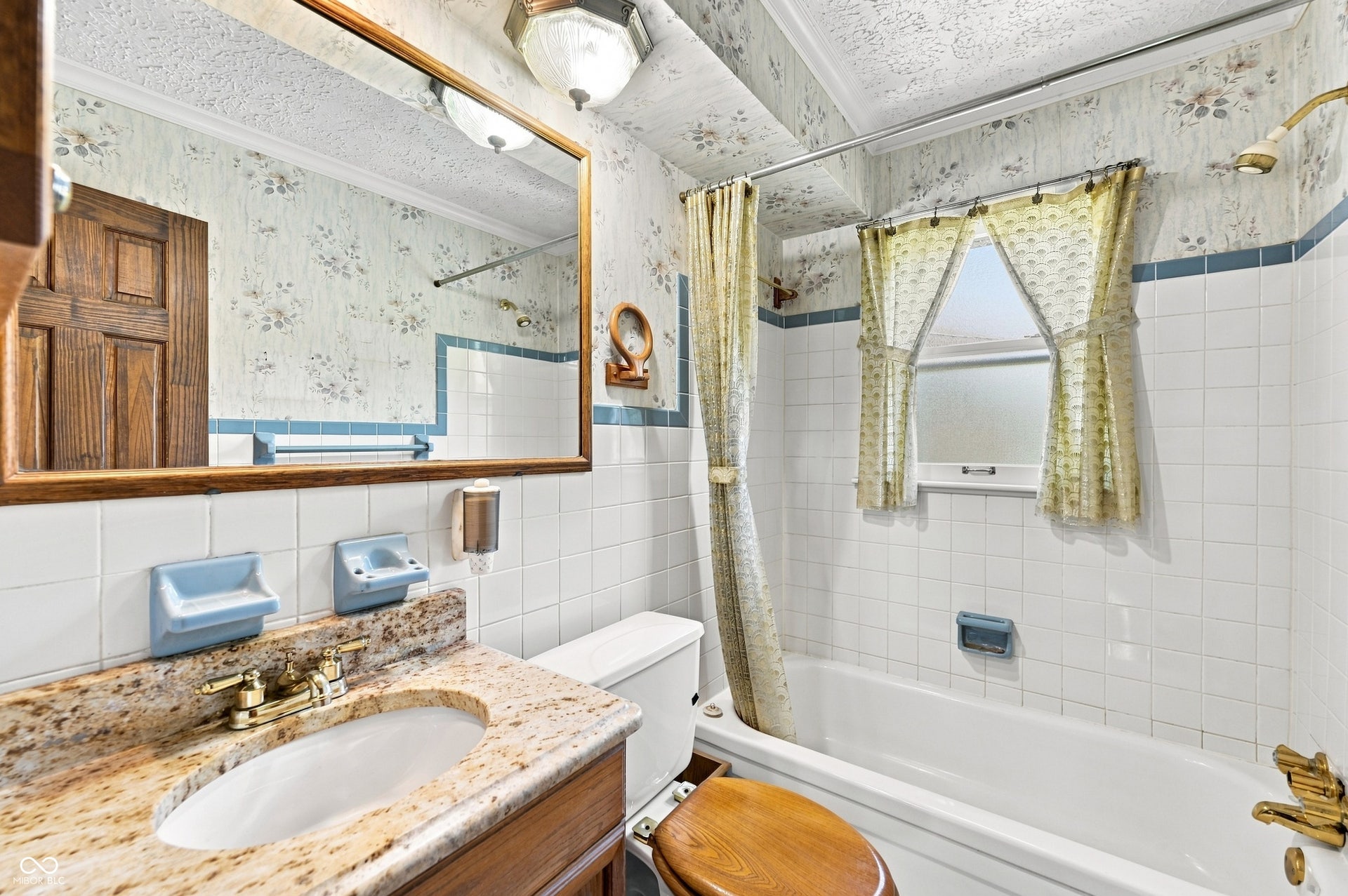 Hall full bathroom with that retro style with original tiled walls, granite top vanity.