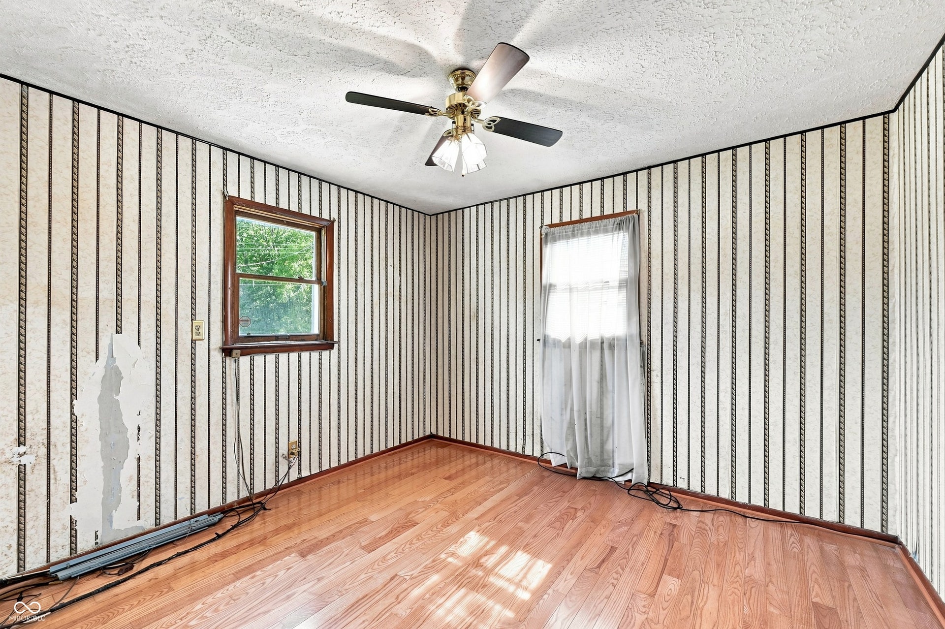 12 x11 Primary Bedroom with hardwood floors and ample closet space.