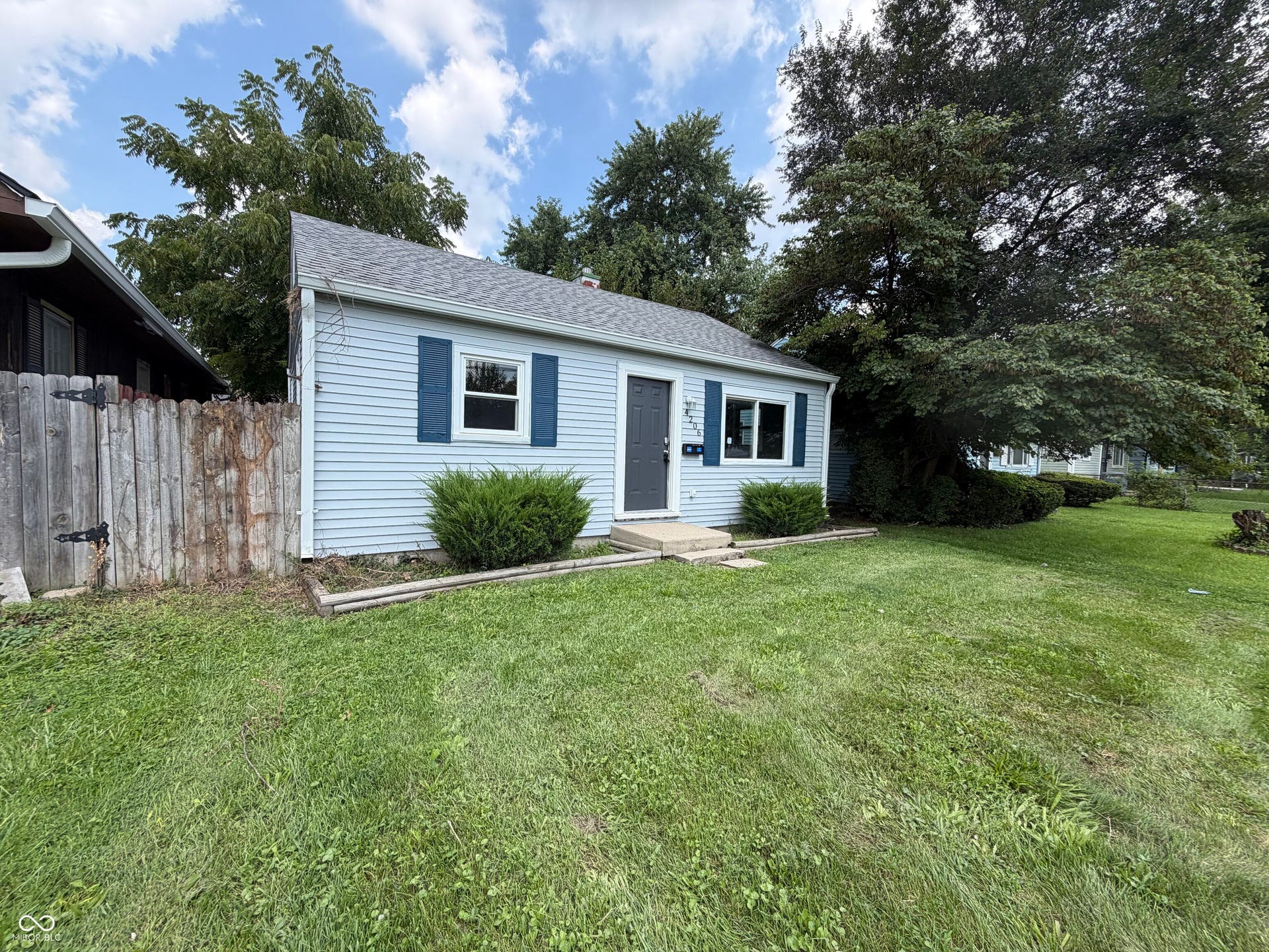 Light blue siding exterior with dark blue window shutters