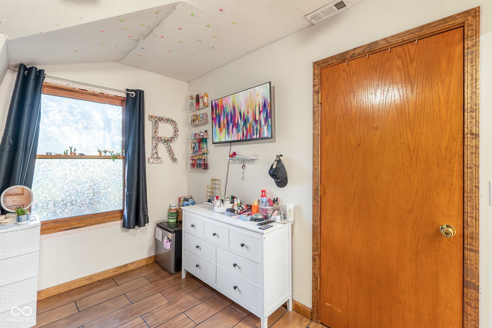 Wood-finish flooring with a natural wood door frame and window frame