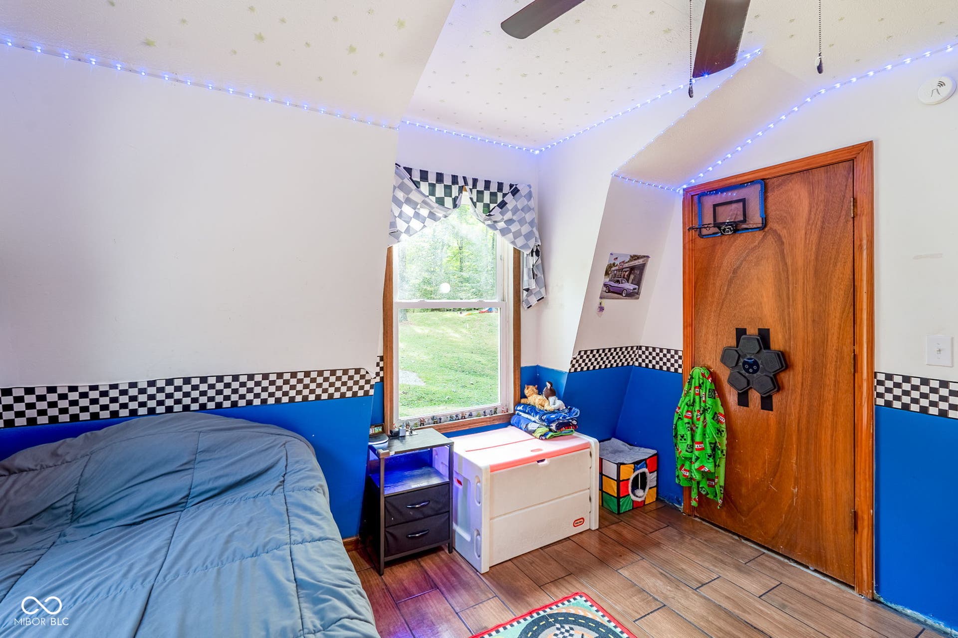 Sloped ceiling with recessed lighting, wood-finish flooring, and a ceiling fan