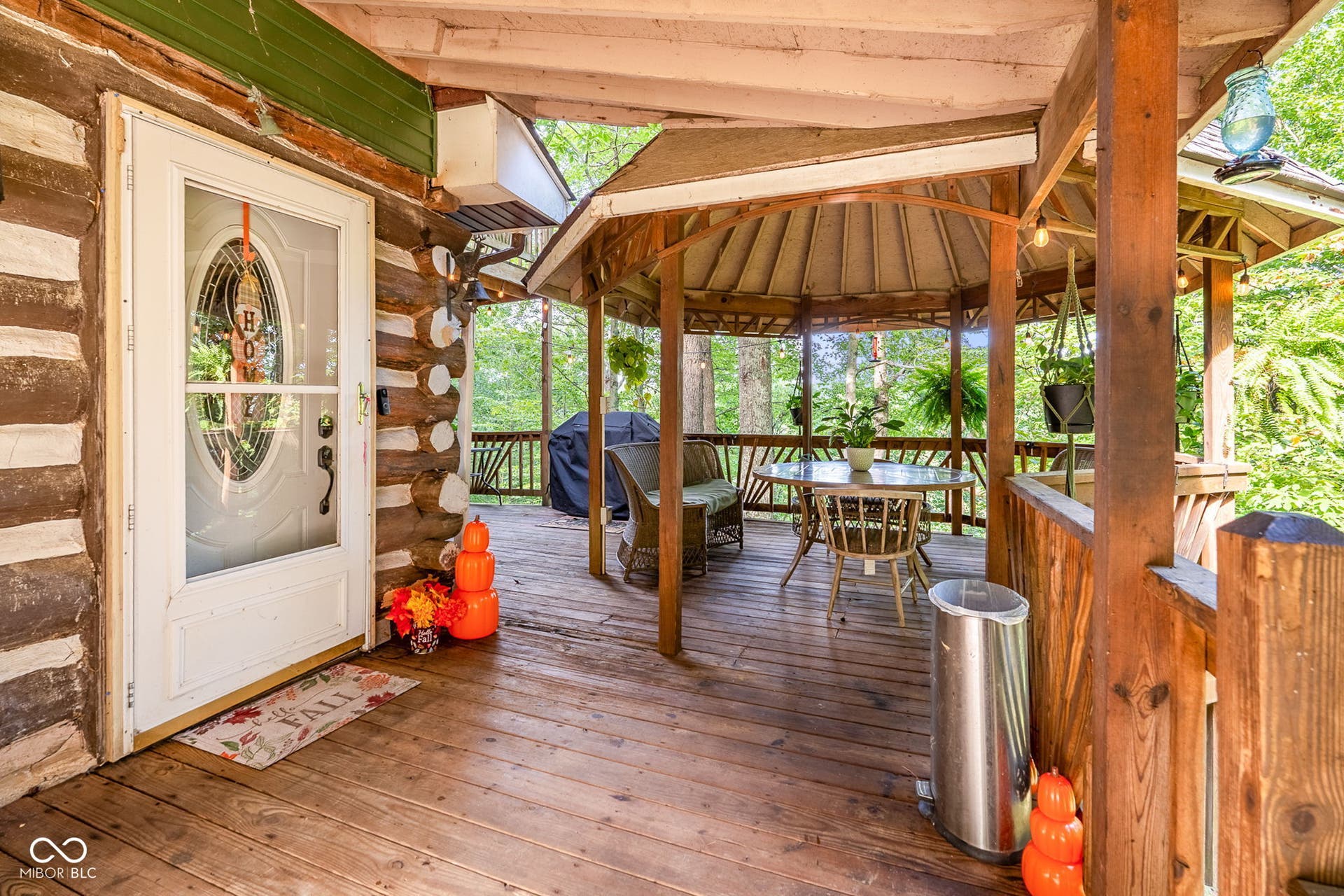 Wood-sided exterior with an entry door featuring a full-light oval insert